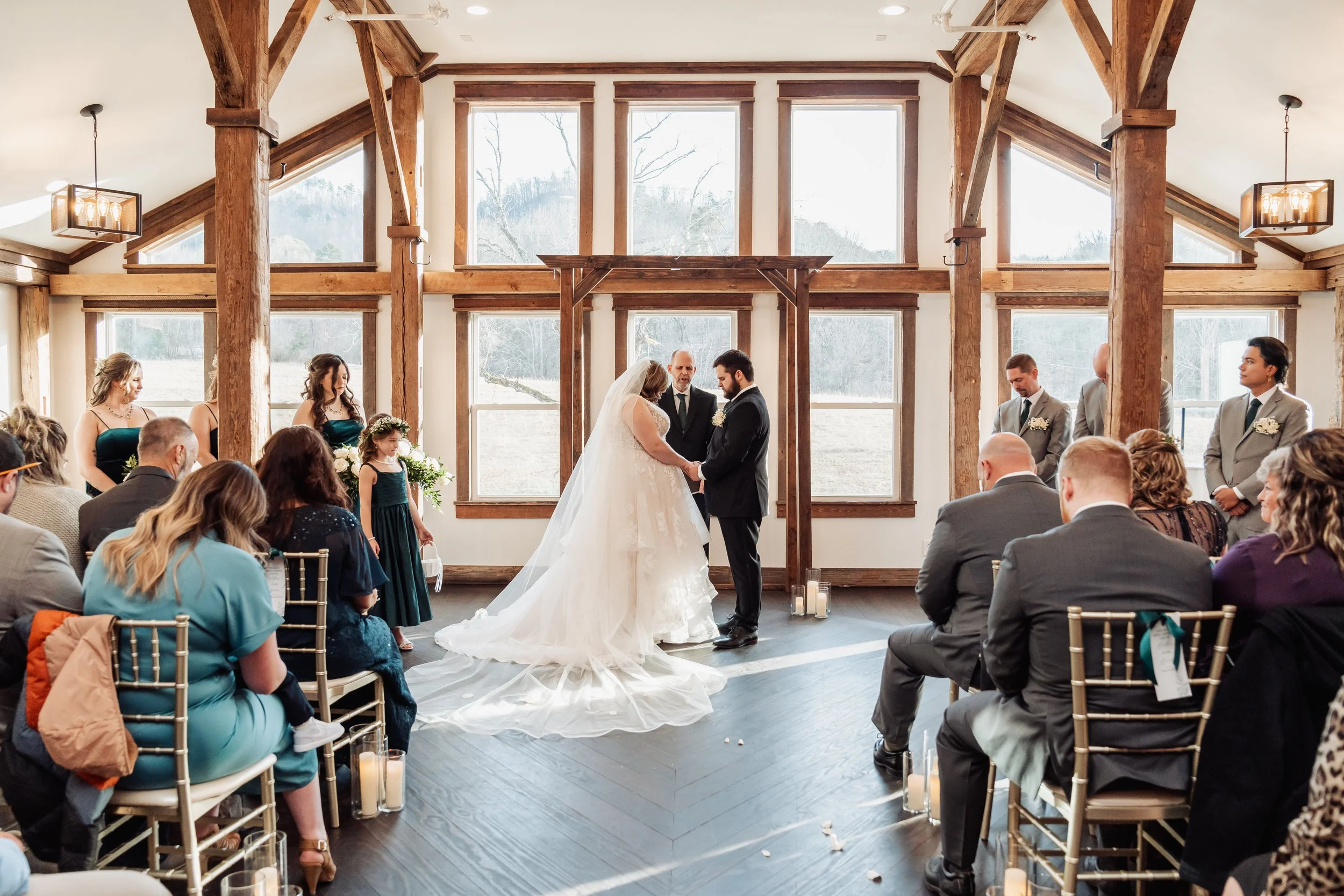 The ceremony location is displayed in this photo, featuring large windows and wooden beams.