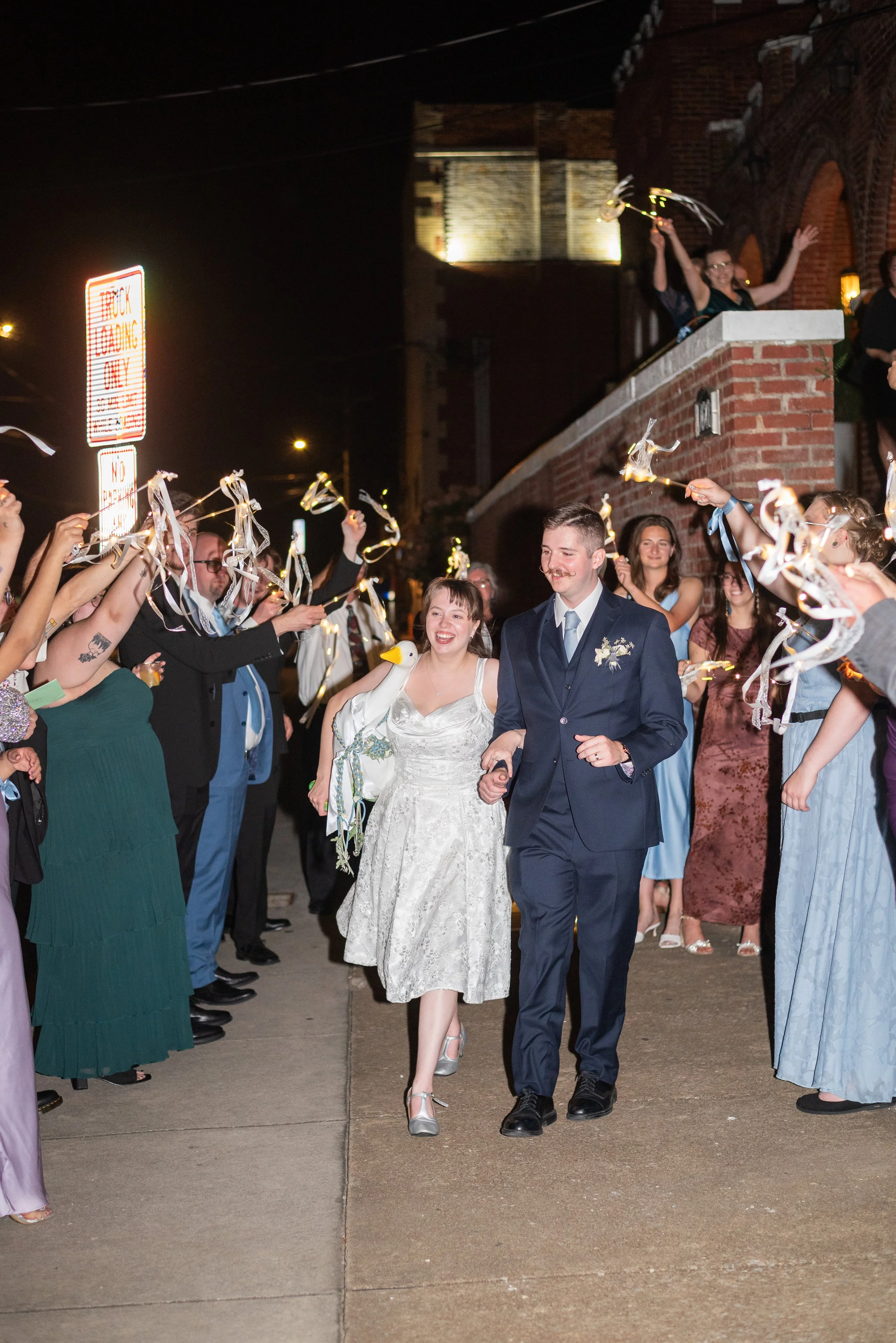 A couple exits the Historic with sparklers from guests.
