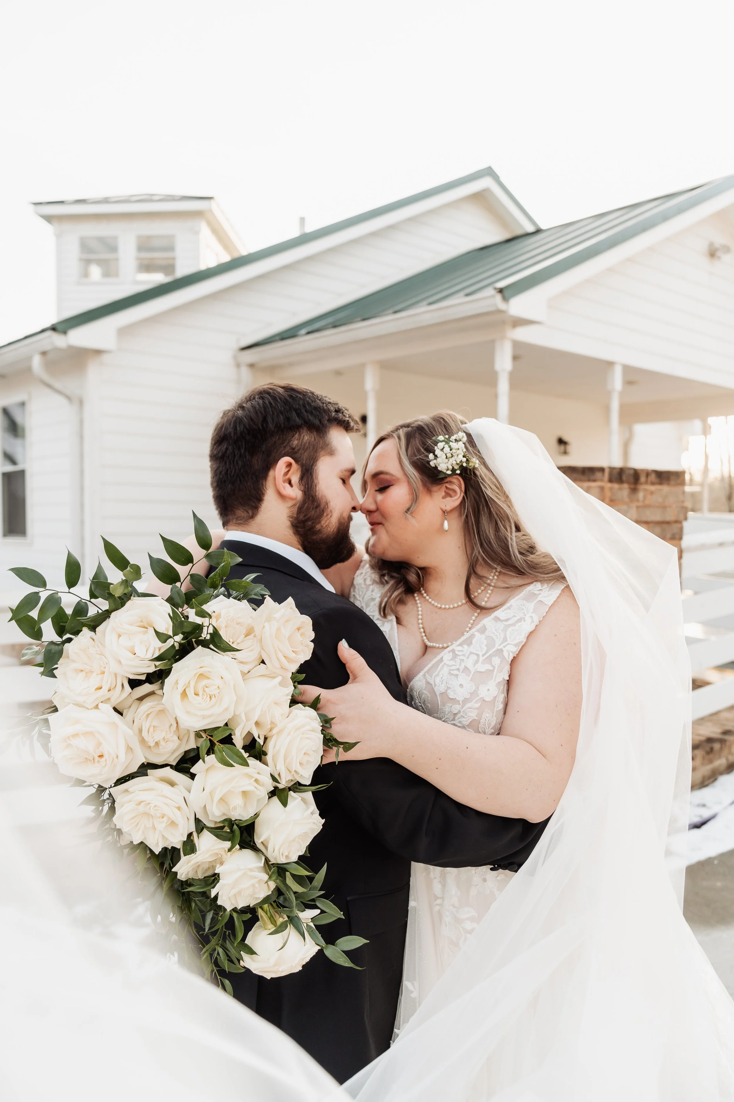A couple is pictured closeup embracing each other.