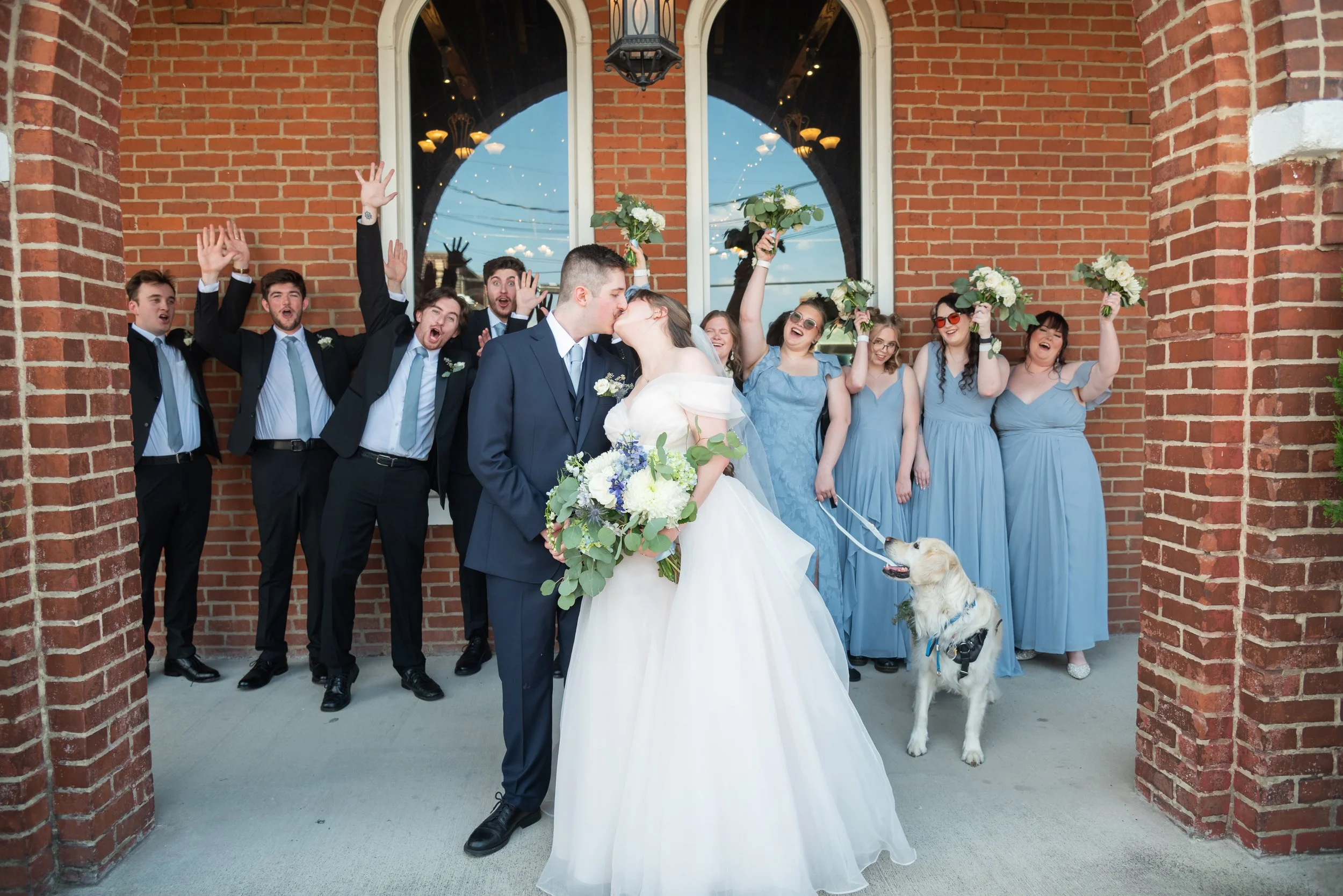 A bridal party gathers outside of the Historic to cheer on their friends who just got married.