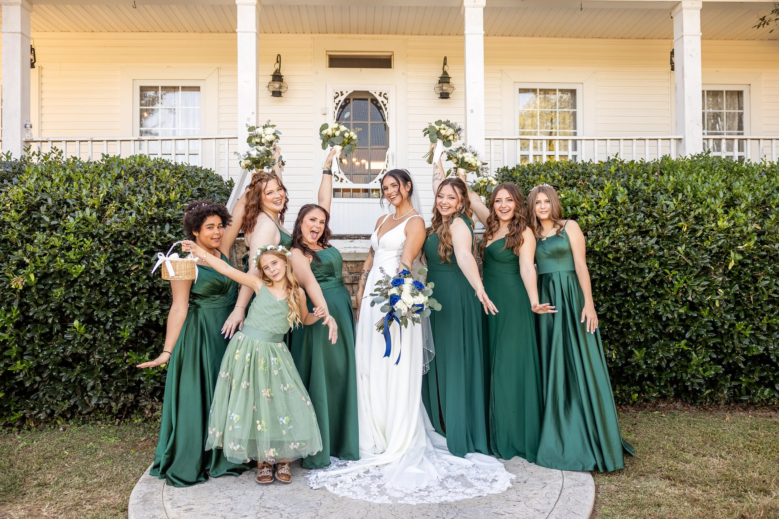 Bridesmaids and the bride pose outside of their plantation venue.