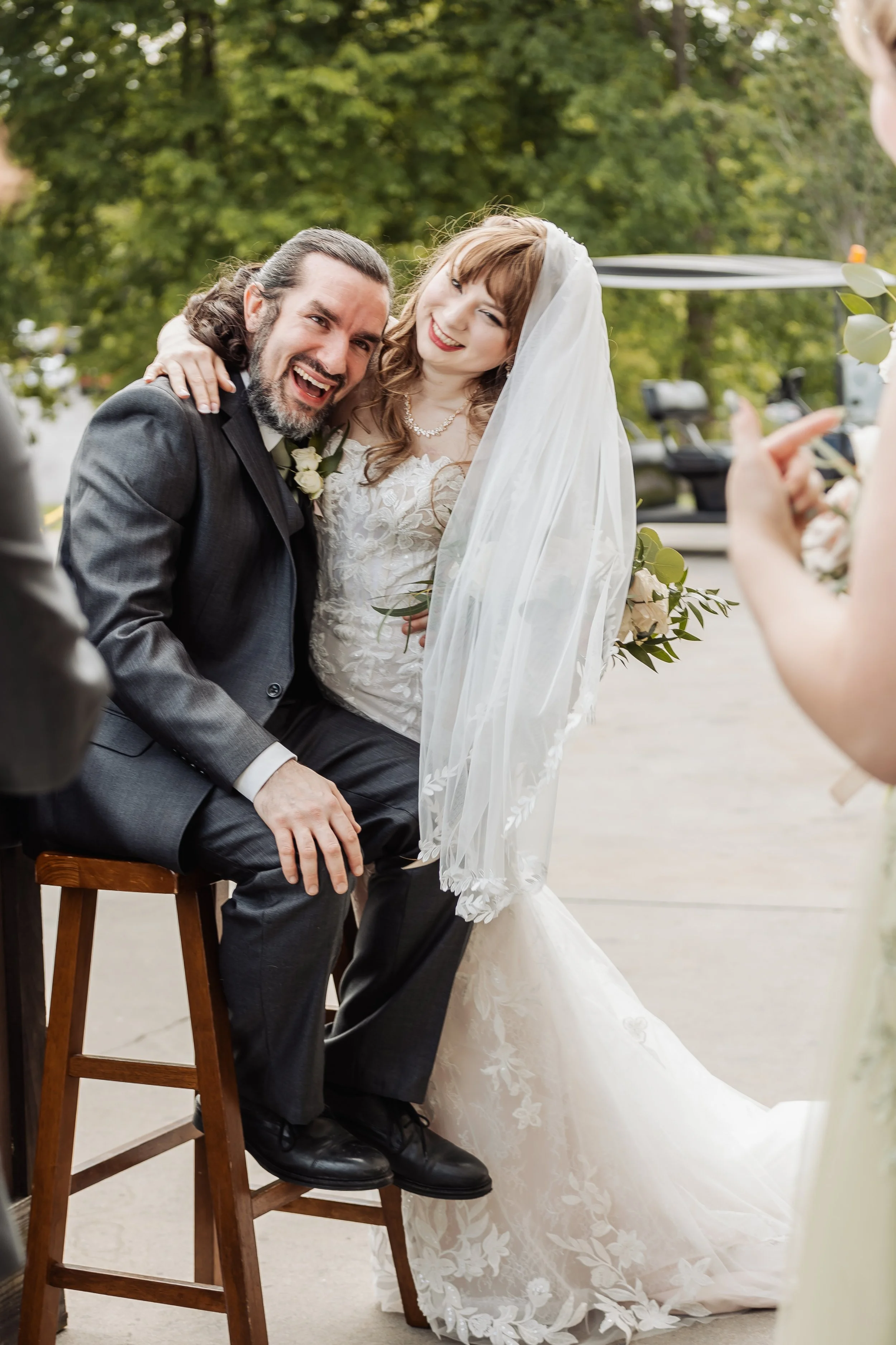 A couple is laughing and smiling at the camera.