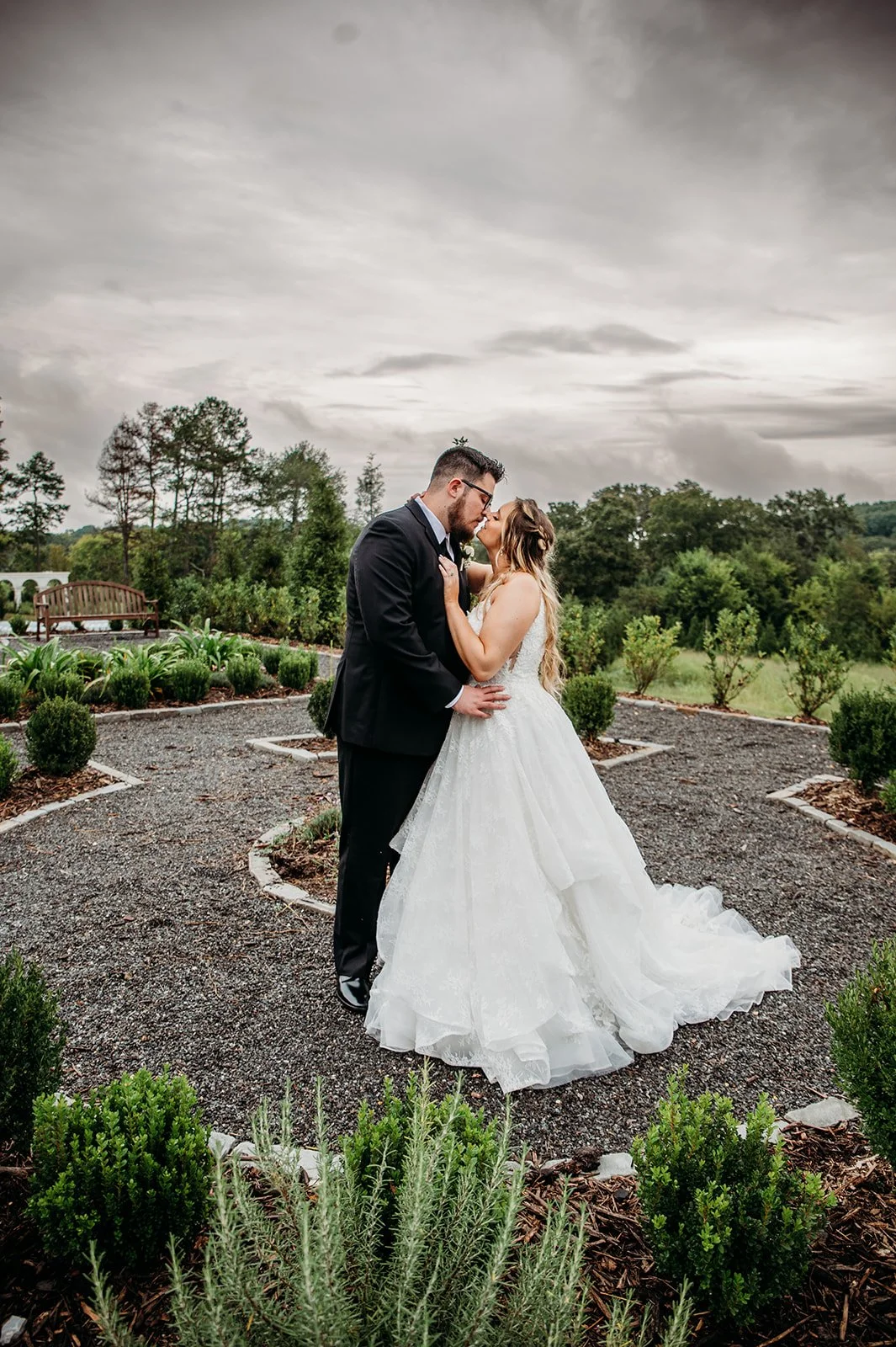 A couple stands outside the Woodlands venue at Howe Farms.