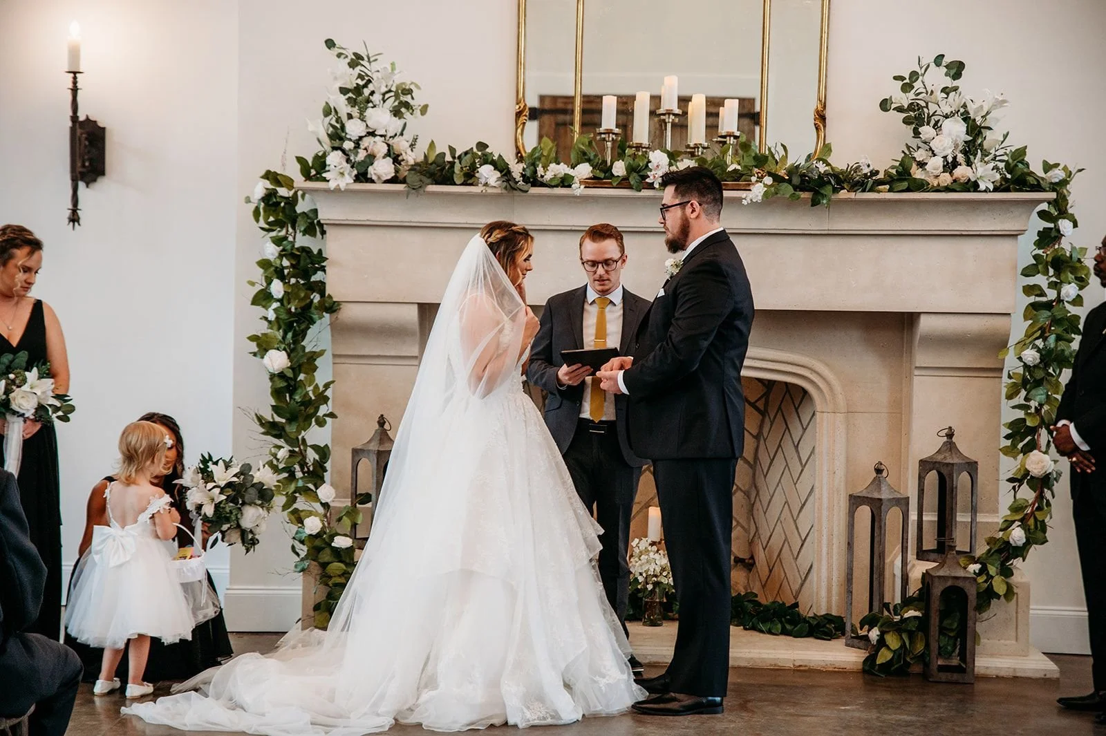 A bride and groom get married at The Woodlands at Five Gables fireplace.