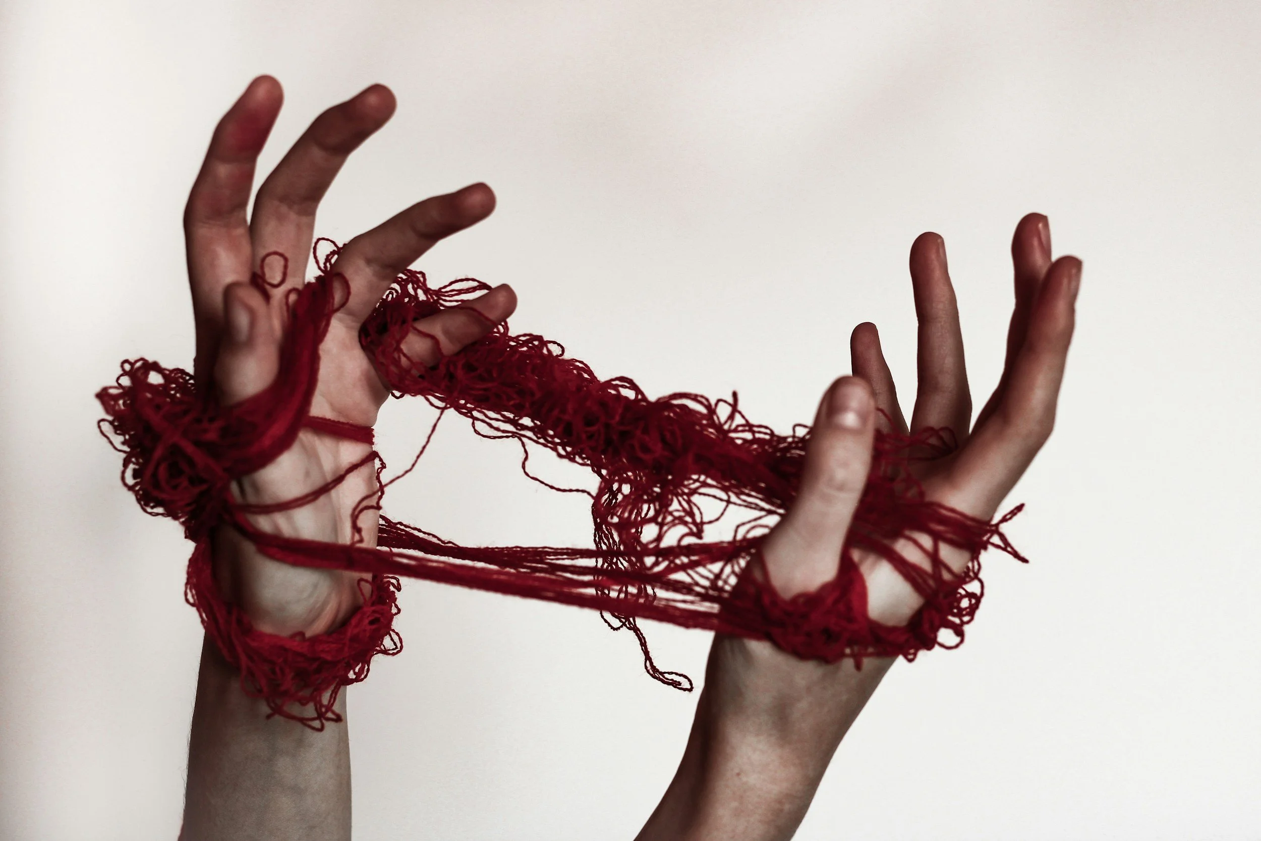 Depth Psychology image- tangled yarn in hands