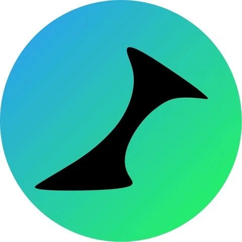 A man with dark, curly hair and a beard, wearing a blue shirt, smiling at the camera against a plain, light-colored background.