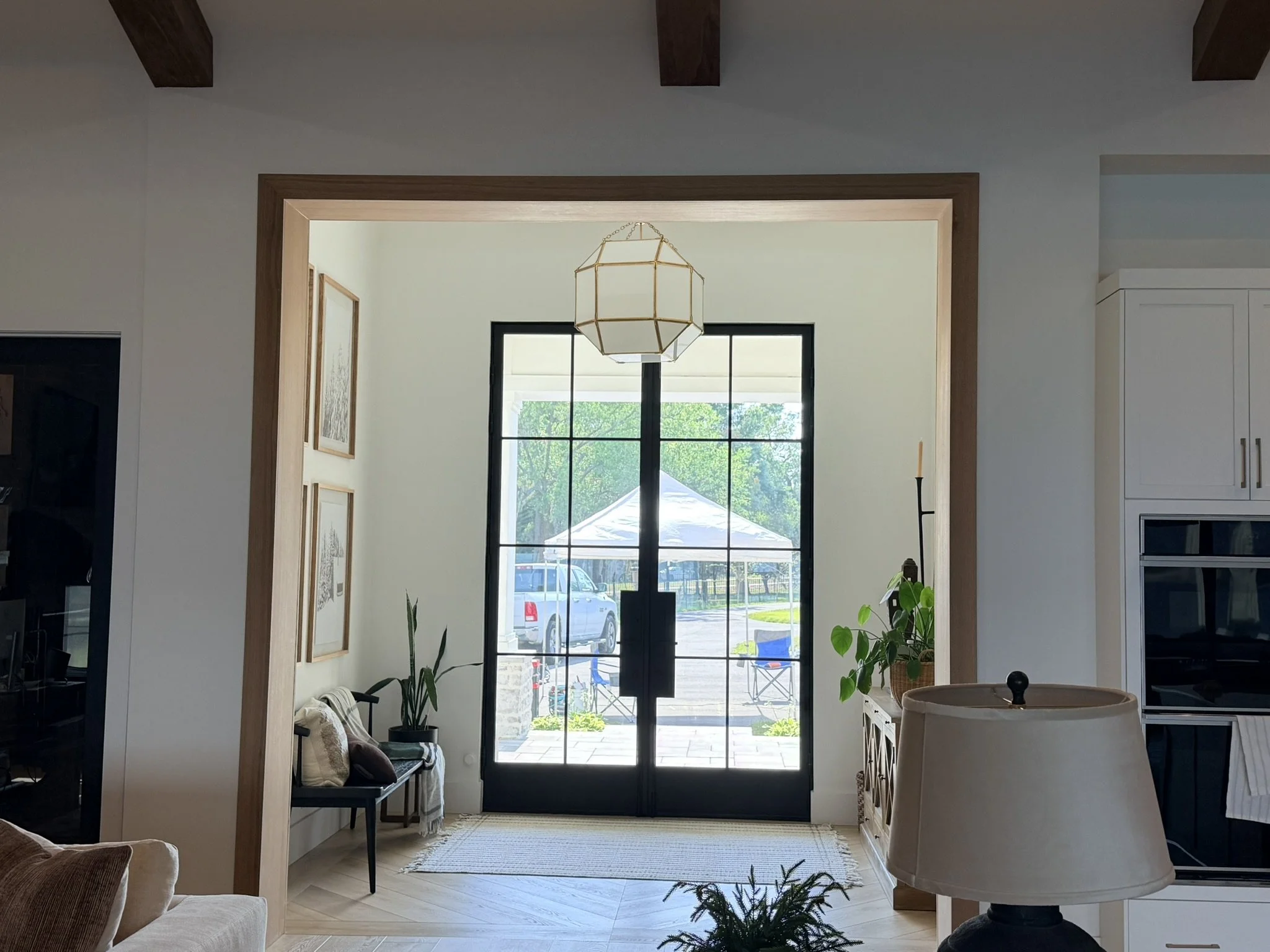 White oak entry opening with custom trim and luxury home interior