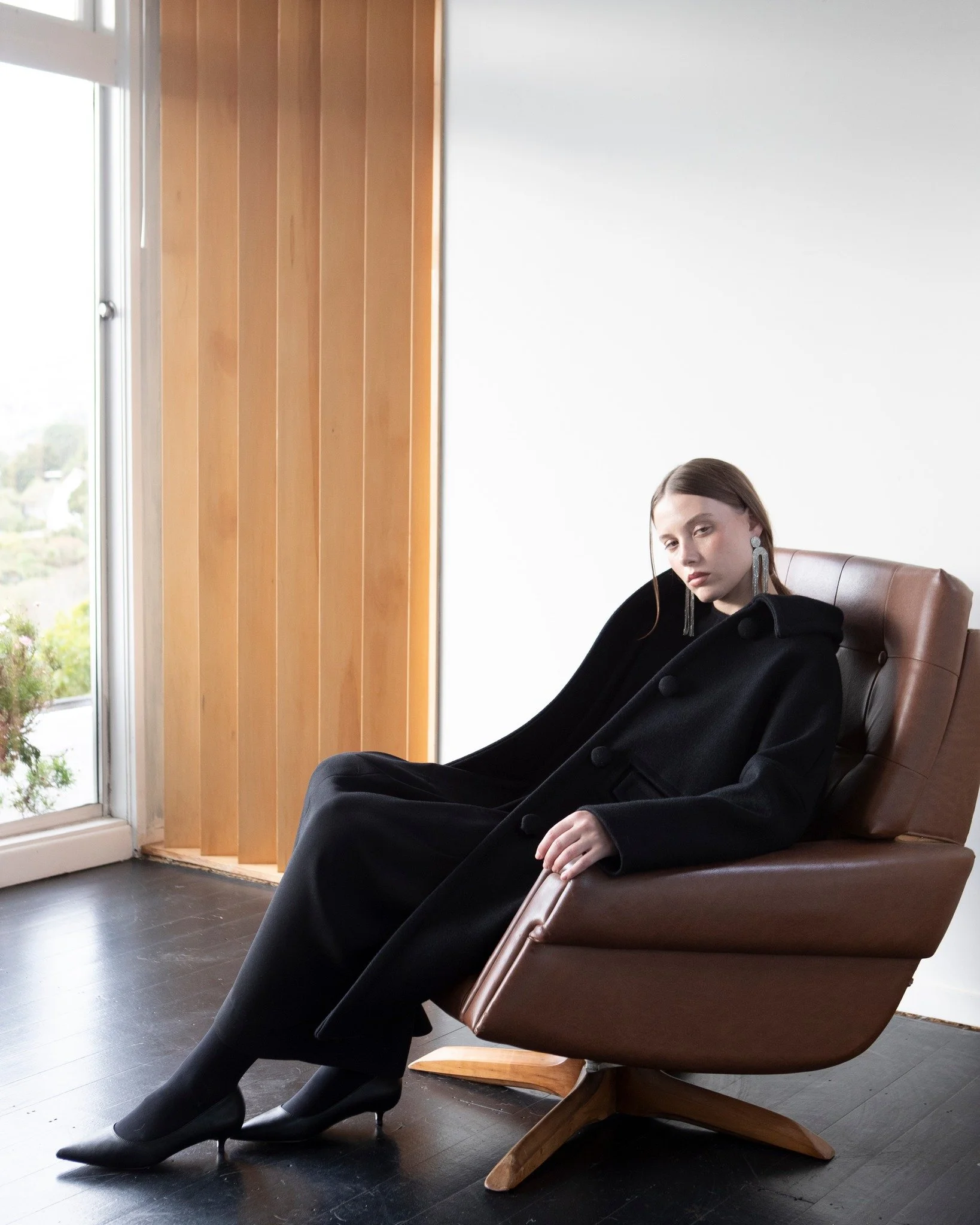 Seated, but making a statement in our Charlotte coat and Daphne Dress.