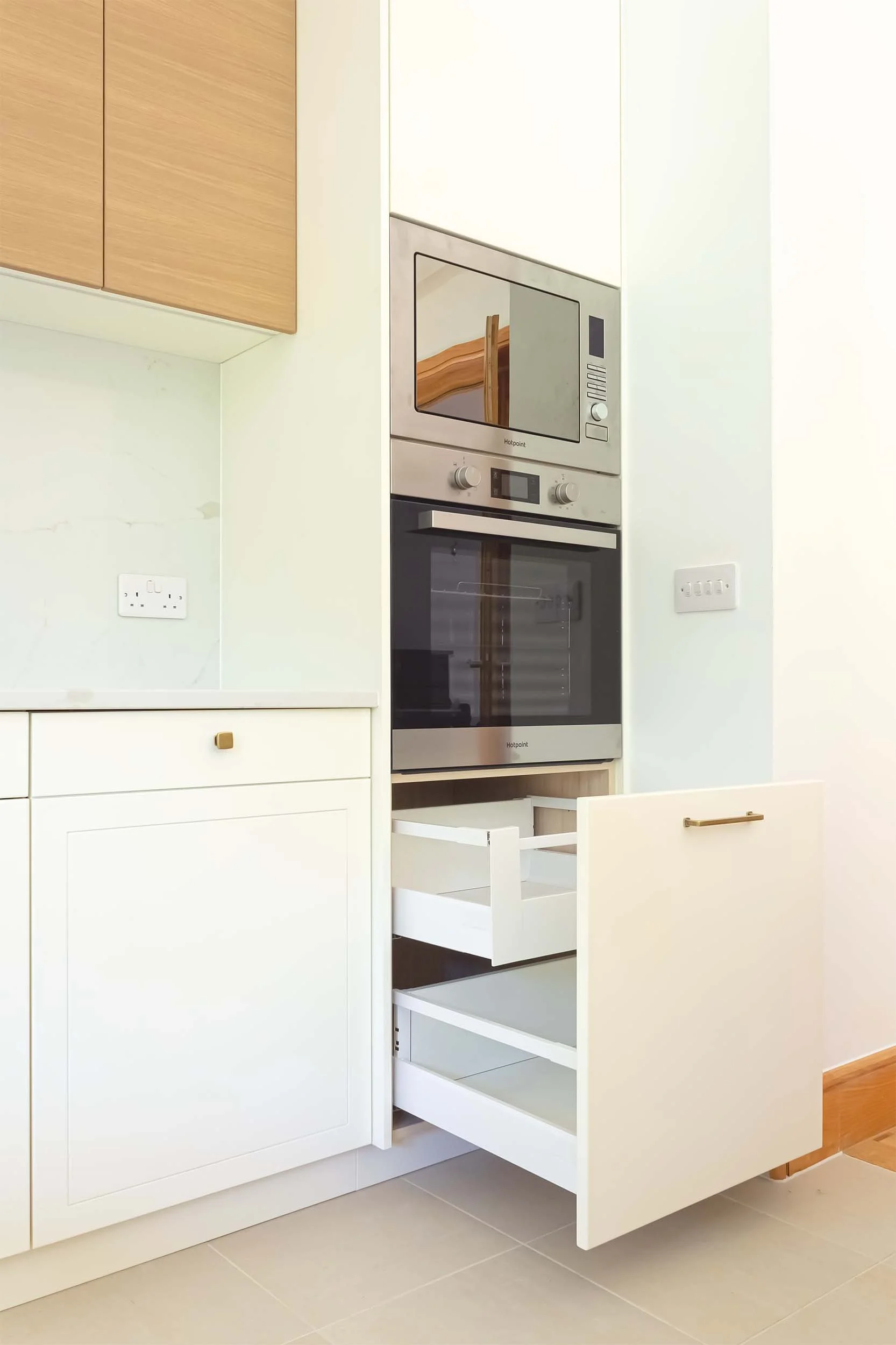 off white cabinet drawer opened to show shite drawer system from blum