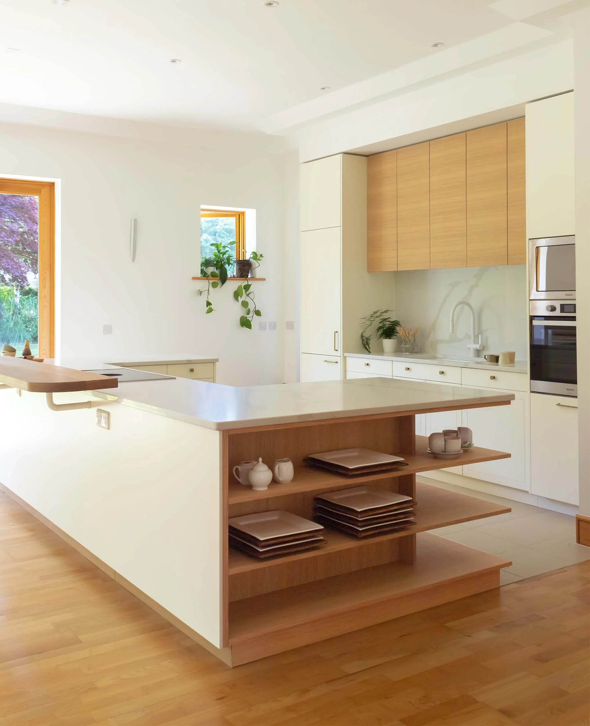 full shot of kitchen and exposed timber shelving with plates and cutlery inside