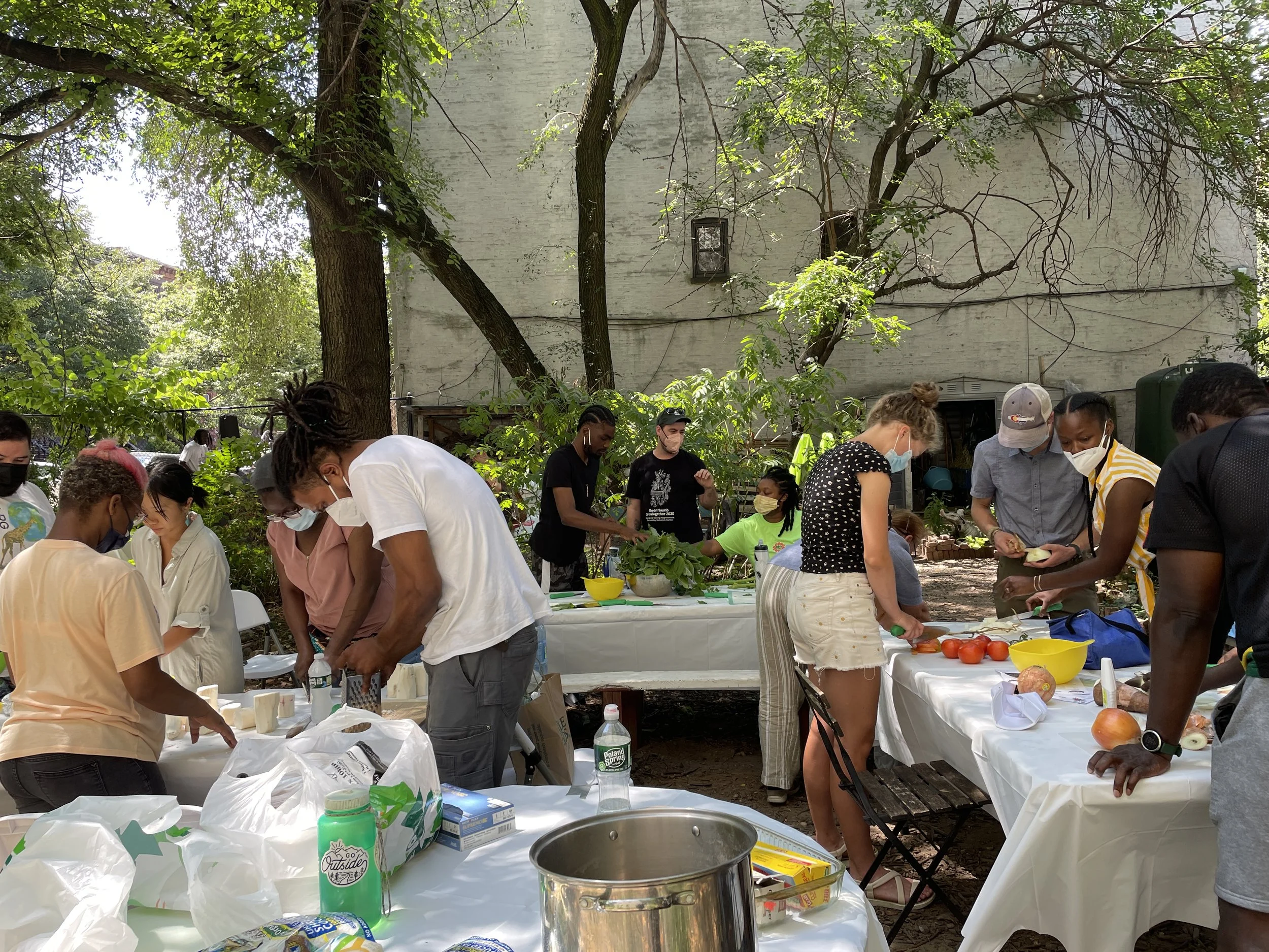 Workshop attendees chopping, dicing, mixing and mincing towards a communal meal.