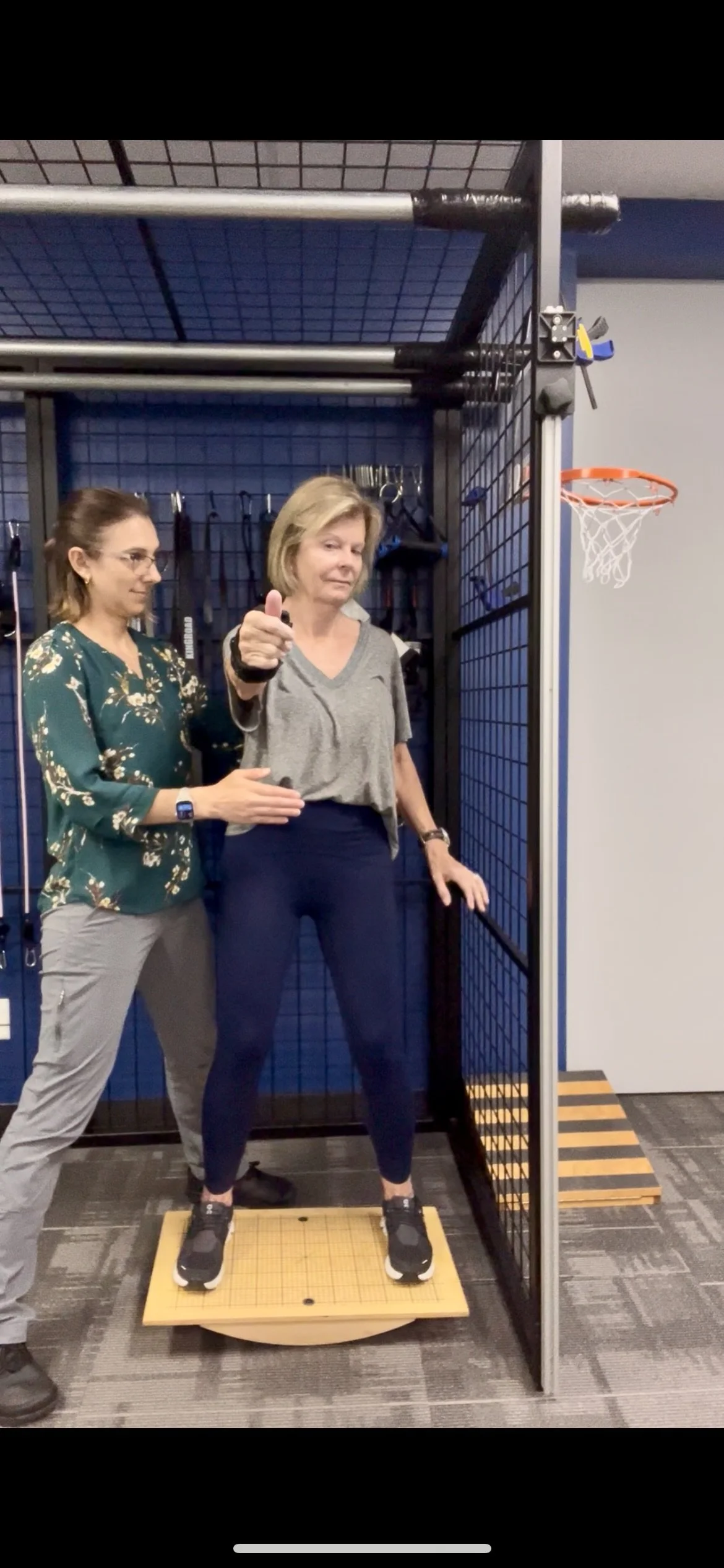Woman performing vertigo exercise with physical therapist