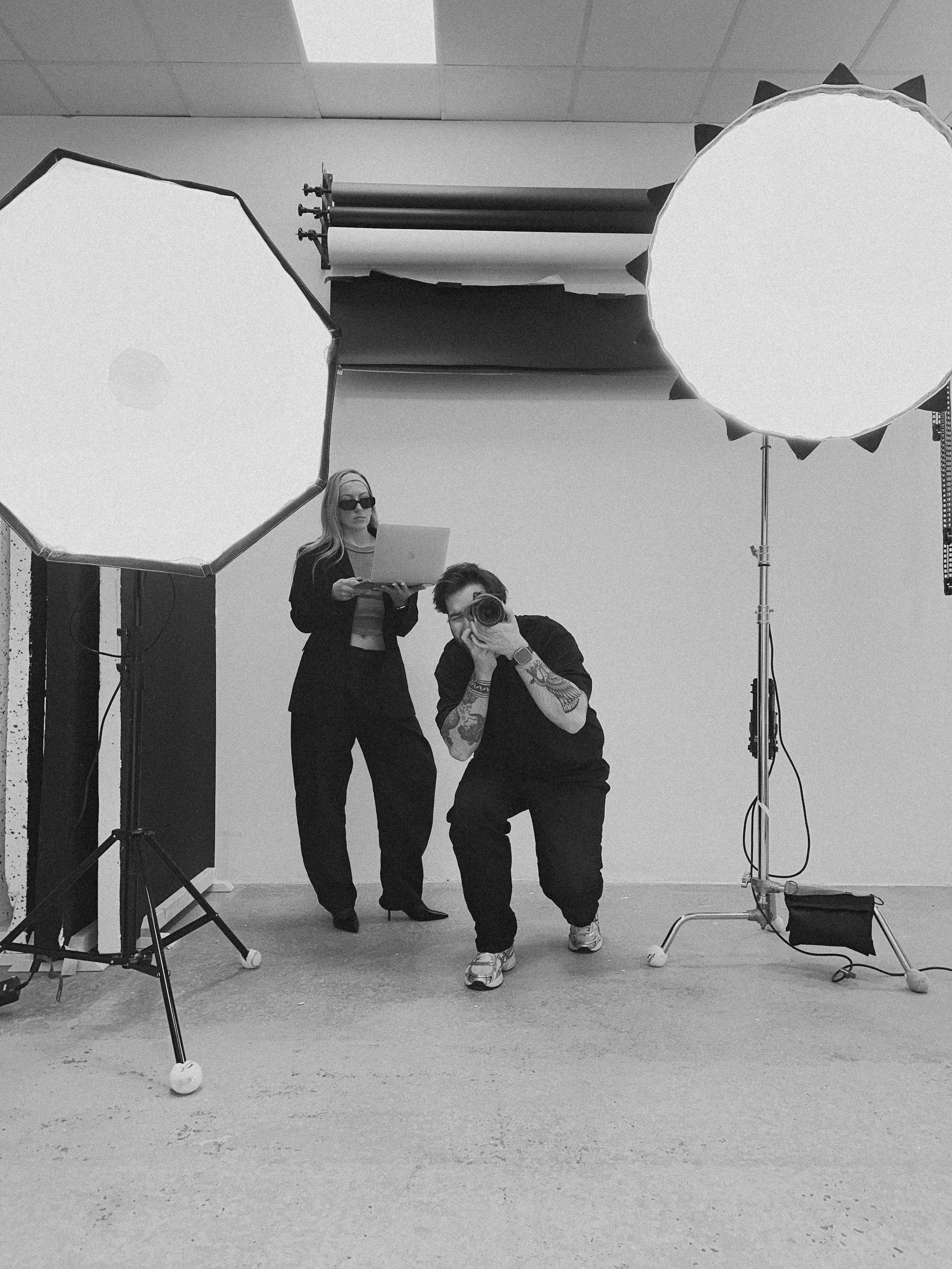 Alex and Jenny of KoaStudios on a studio shoot, reviewing footage behind the camera