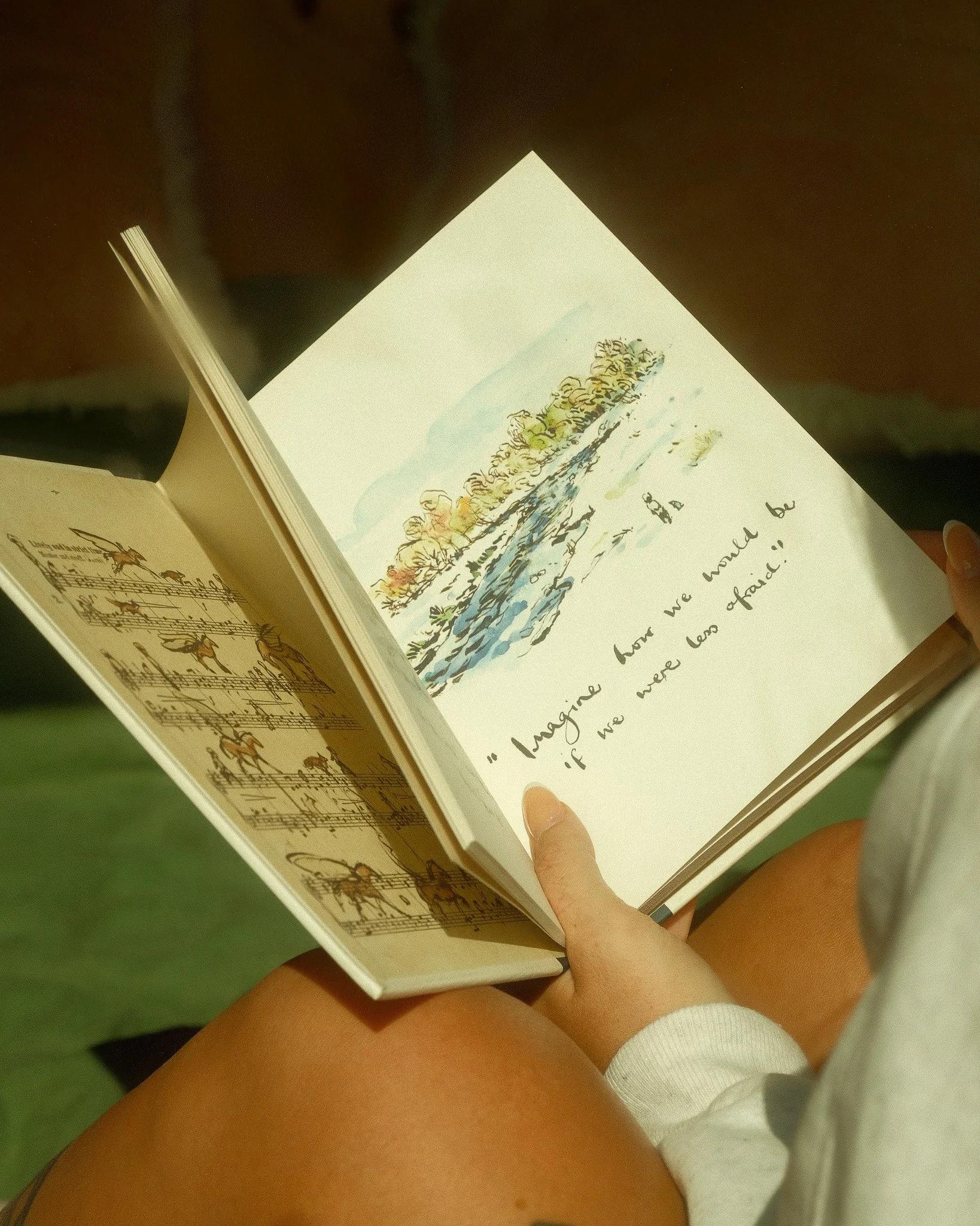 A book and blanket by the cabin window at Unplugged