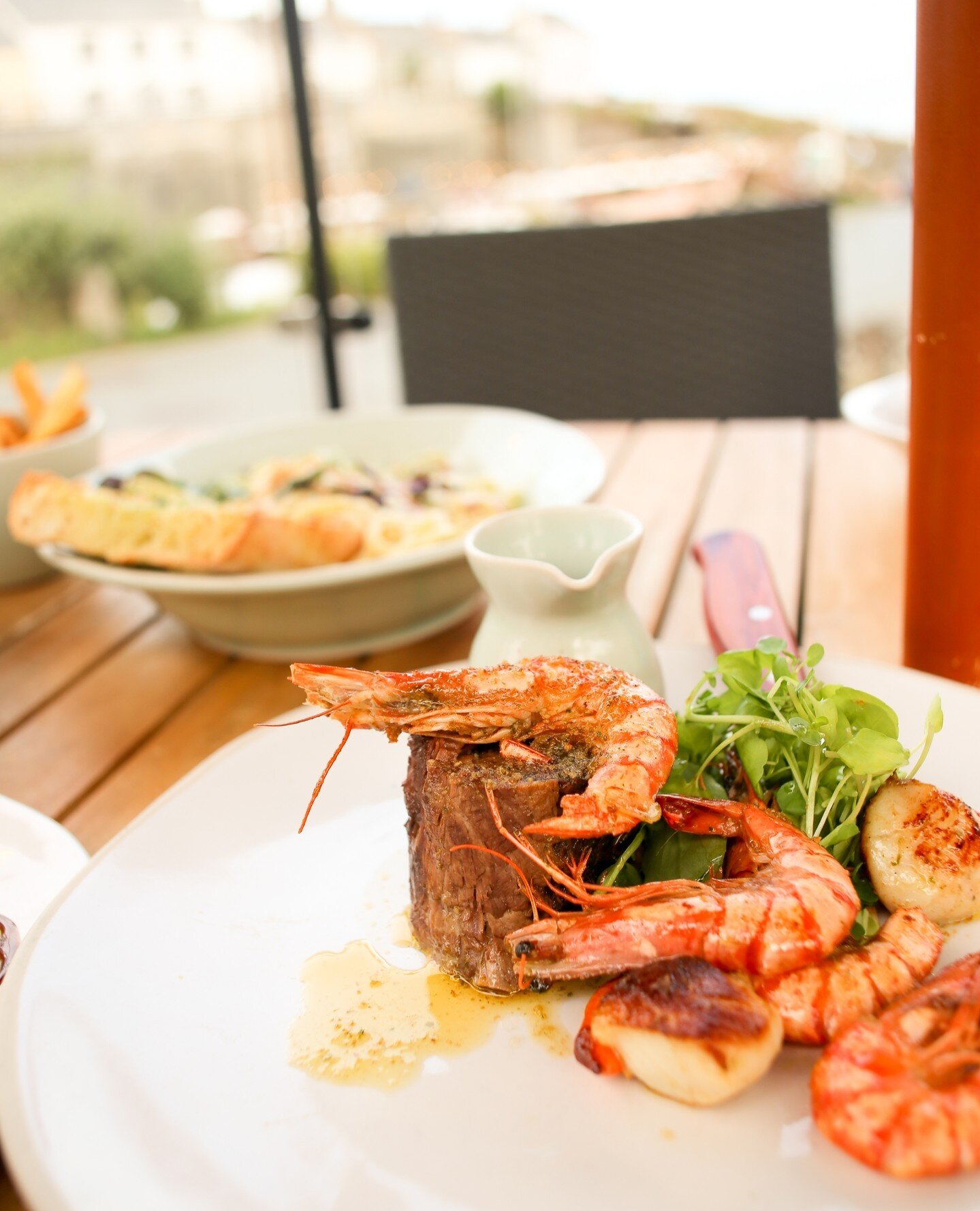 Surfin' and Turfin' on the terrace🐟🥩. 12-hour blade of Cornish beef, garlic and parsley tiger prawns with scallops. Got you hungry?🤤 ⁠
⁠
#steak #meat #seafood #cornwall #meatlover #grill #bbq #lovecornwall #cornishcoast #kernow
