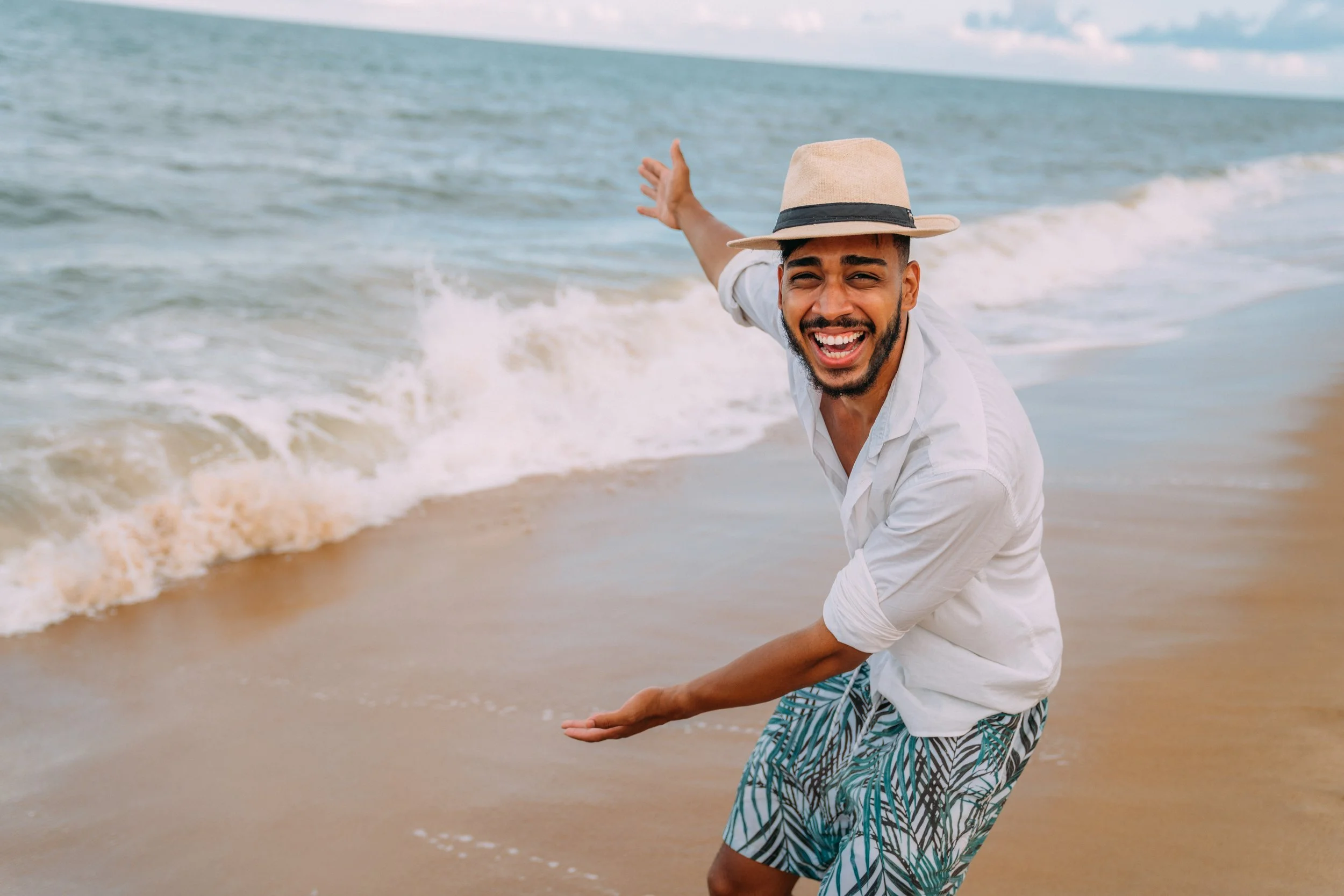 Hombre dominicano feliz en una playa de Estados Unidos.