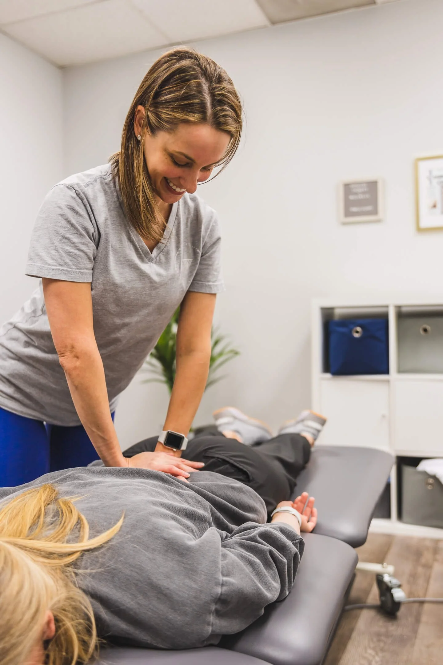 Doctor of physical therapy performing manual manipulation on a patient's lower back to alleviate pain