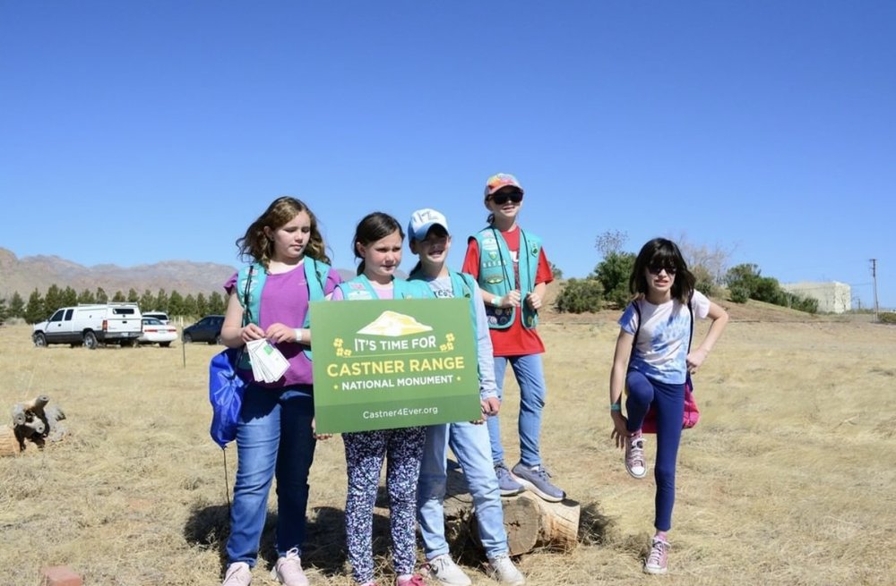 Girl Scouts holding up Castner Range signs. 