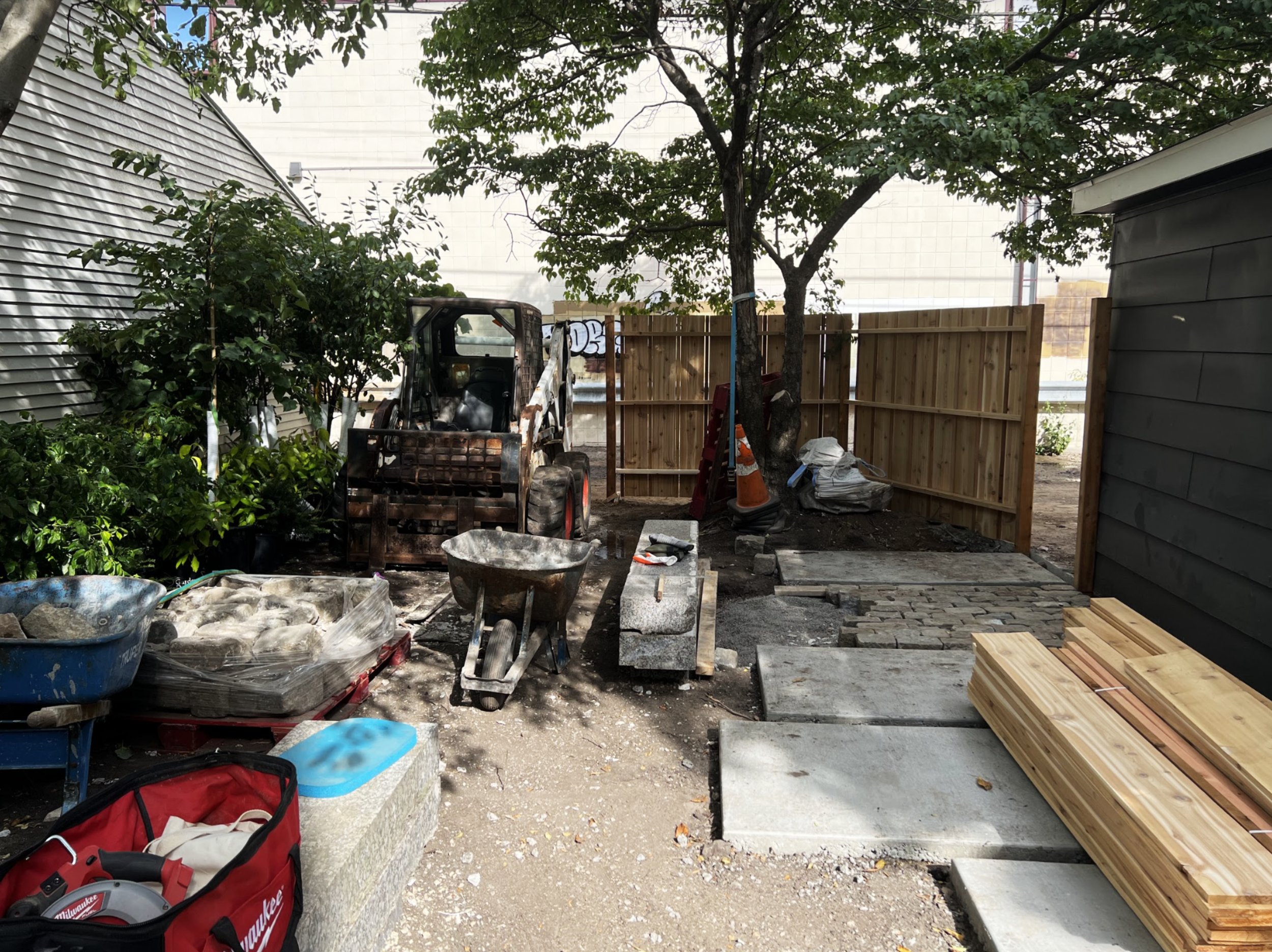 Urban backyard, landscape construction, cedar fence, concrete