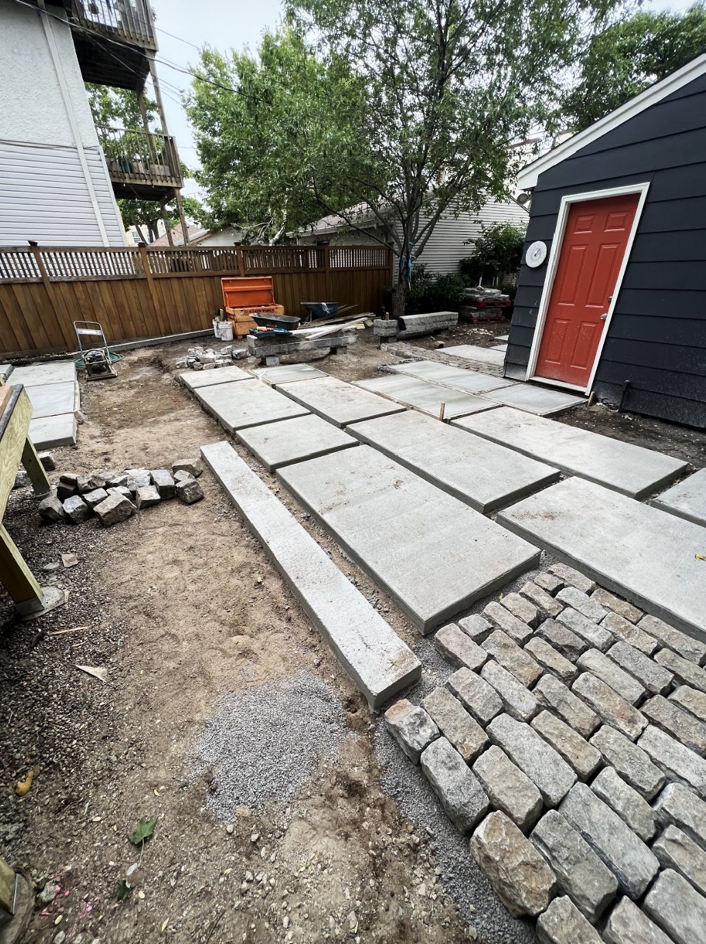 Urban backyard, landscape construction, concrete slabs, cobblestone