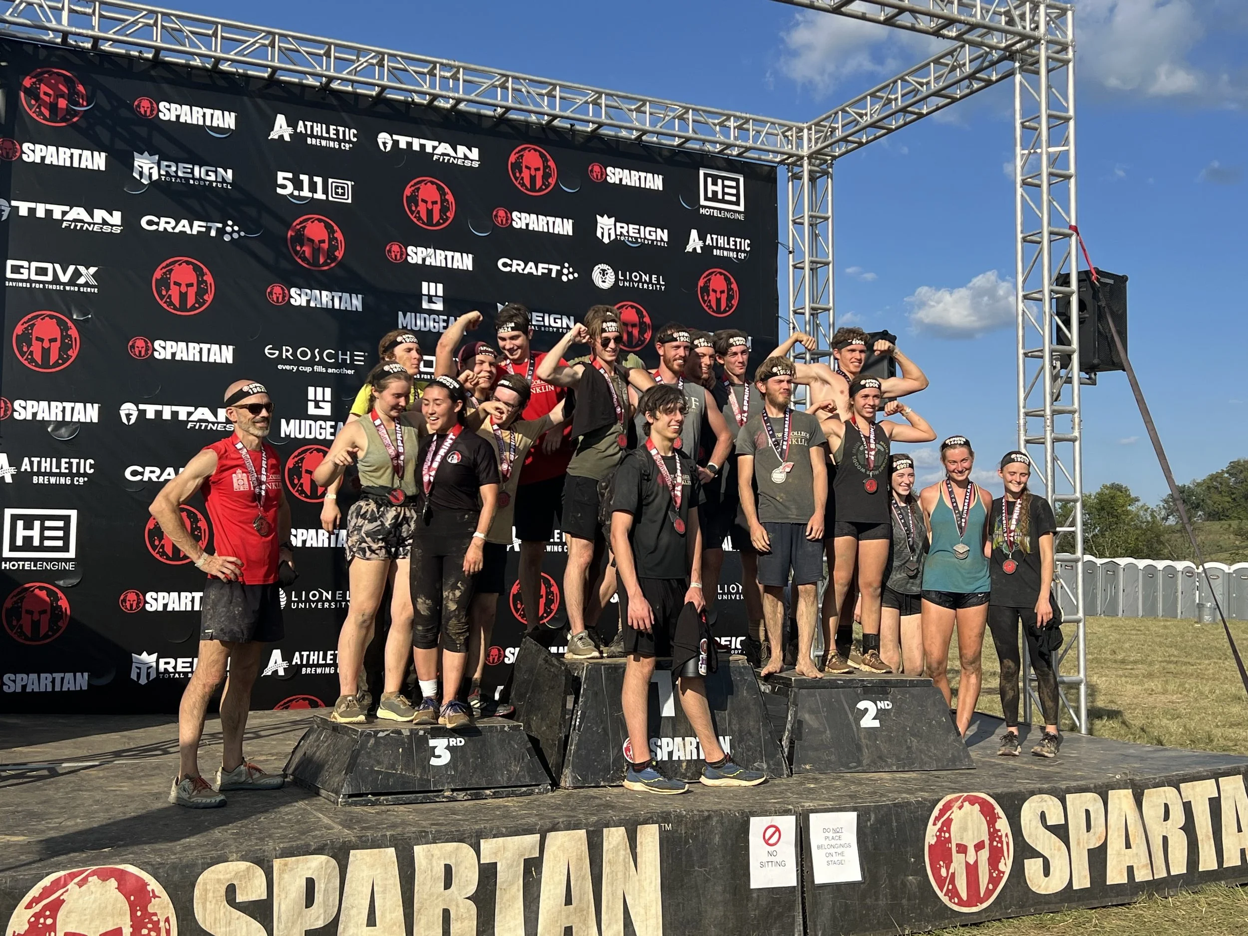A group of students from a Christian school standing on a winners podium.