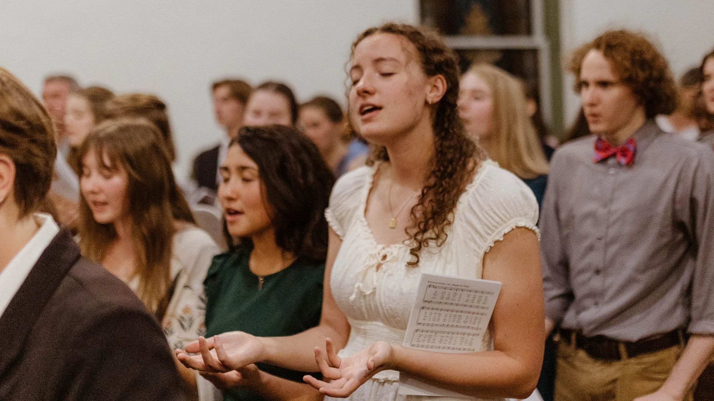 A group of liberal arts students in daily prayer service.