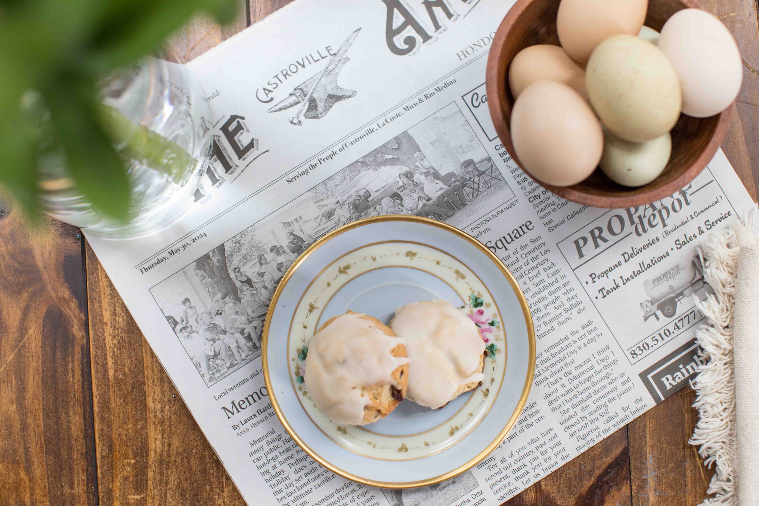 Cranberry Orange Scones on a Blue Plate with a Bowl of Eggs and the Hondo Herald Magazine