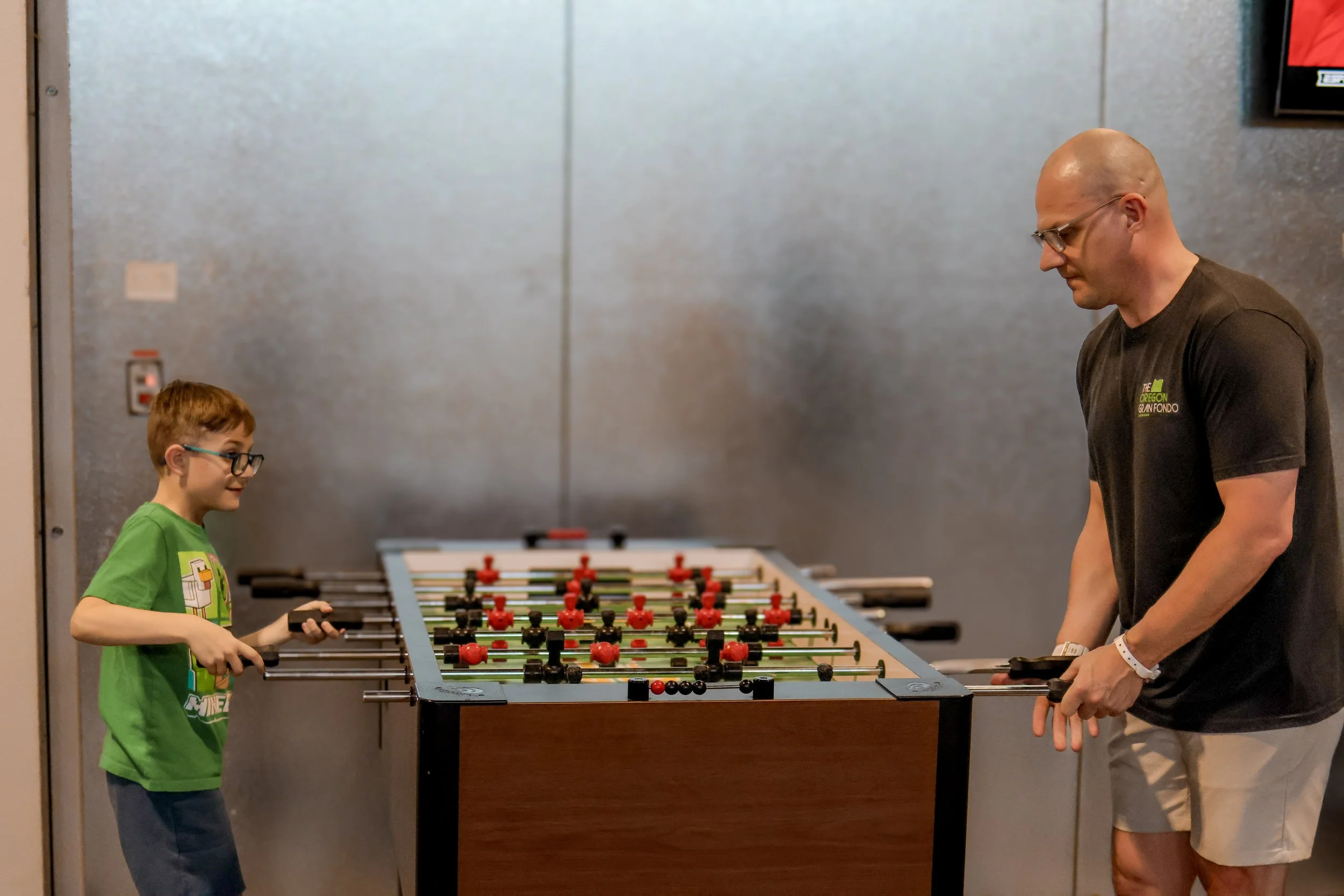 Family playing foosball