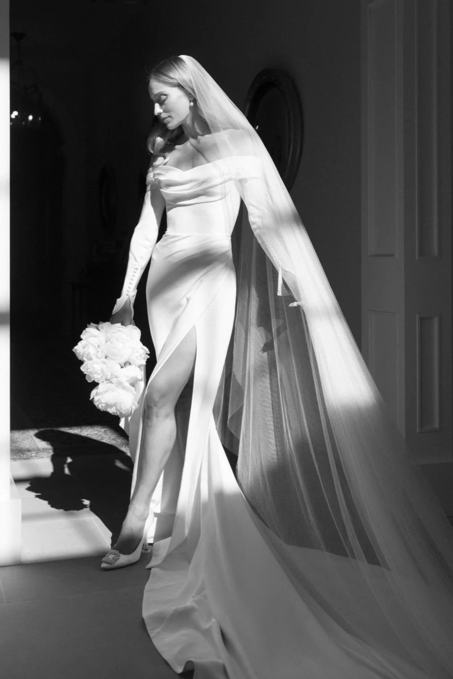 Bride in wedding gown with large bunch of roses