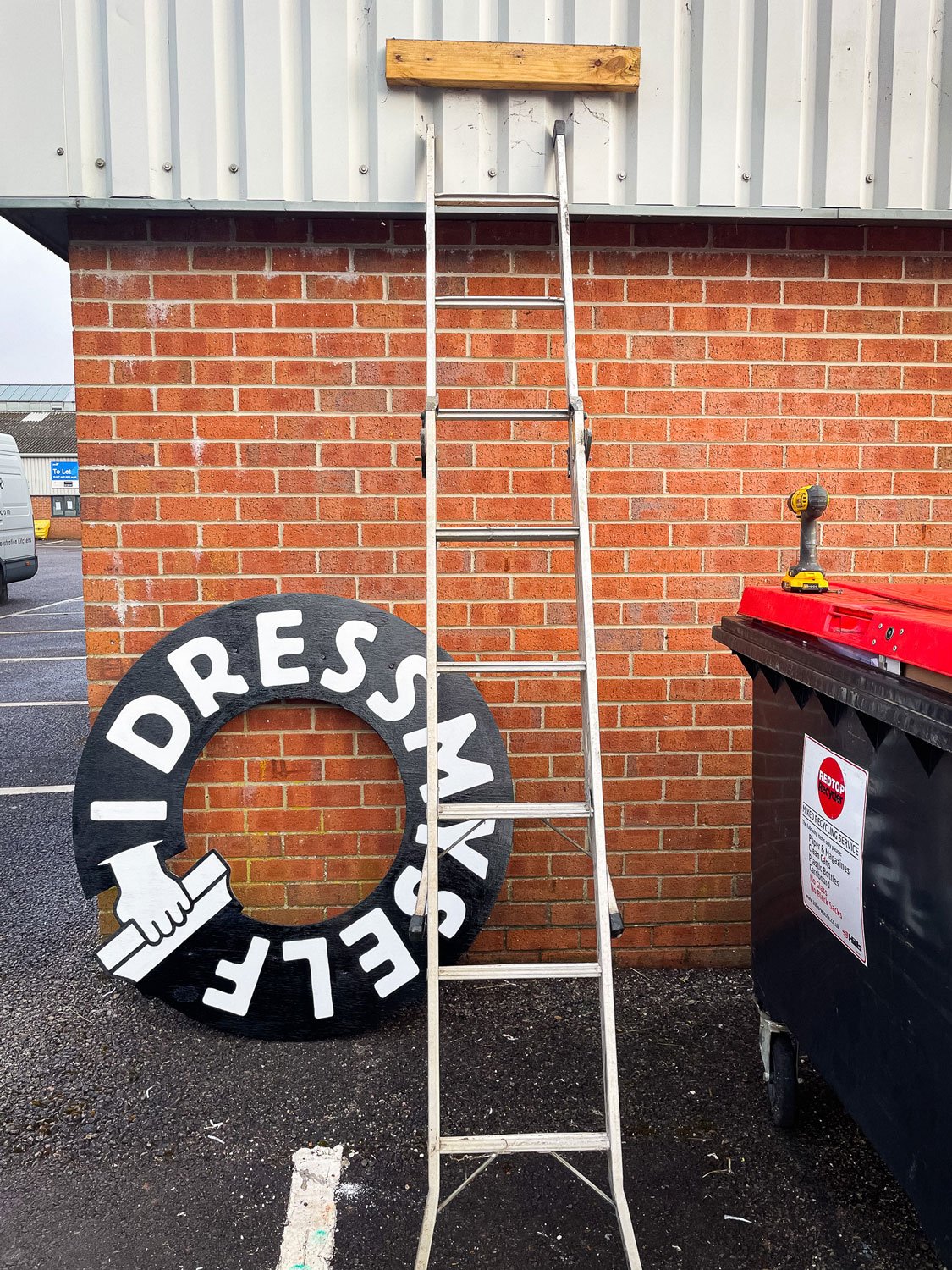 I Dress Myself, a screen printing studio in Frome, asked me to bring their logo to life on the front of their premises. Hand-painted signage design and installation by Rich C Studio, sign painting and graphic design studio, Frome.