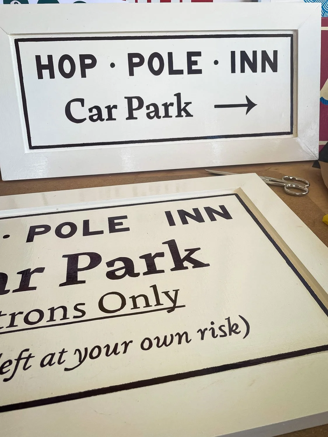 Hand-painted signage for the Hop Pole Inn in Limpley Stoke featuring brand logo, lettering and custom frames, showcasing the craftsmanship of Rich C Studio.