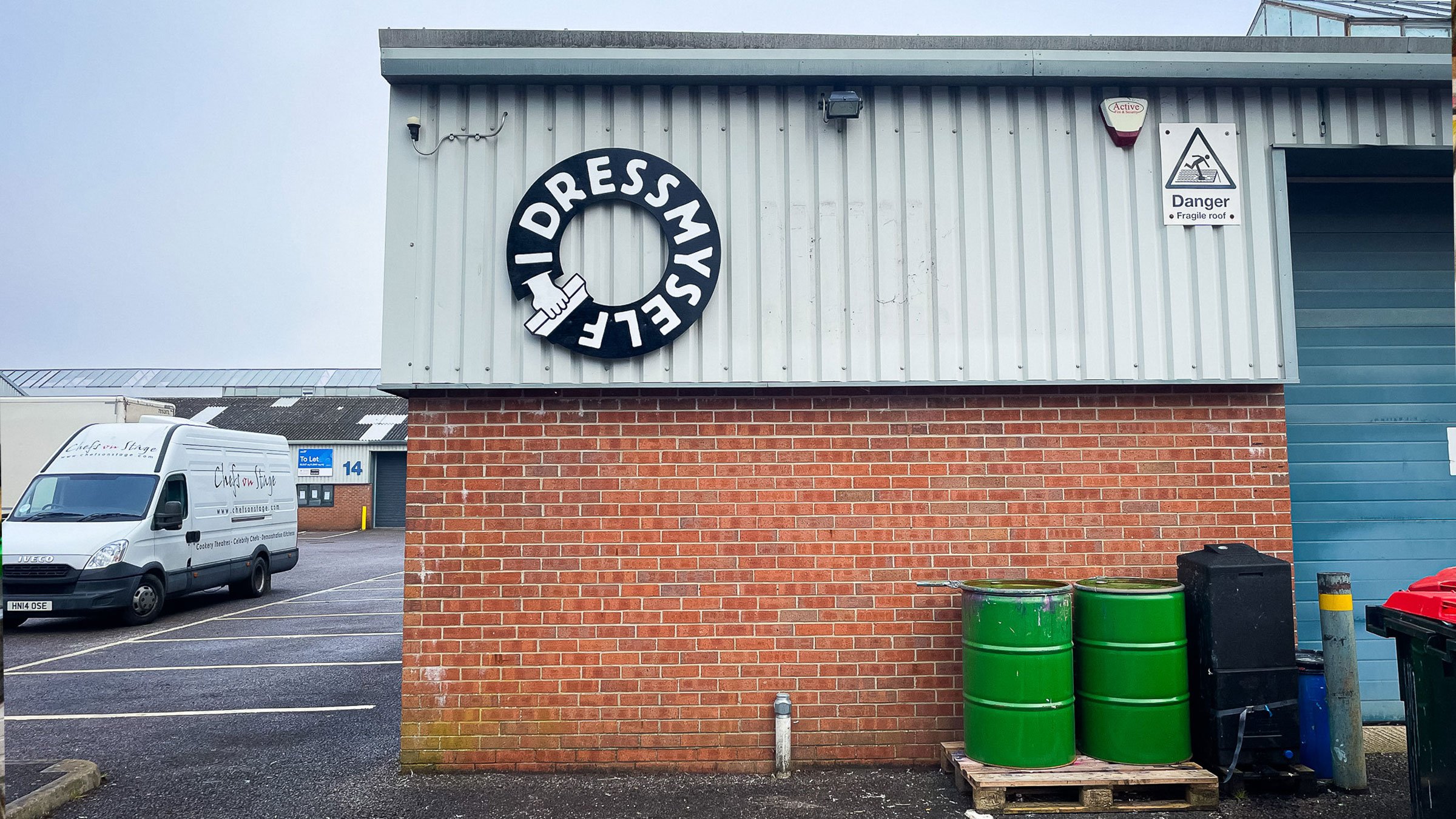 I Dress Myself, a screen printing studio in Frome, asked me to bring their logo to life on the front of their premises. Hand-painted signage design and installation by Rich C Studio, sign painting and graphic design studio, Frome.