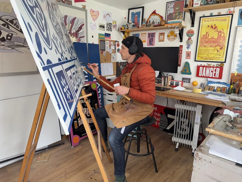 Rich Carter sign painting a Gyros food stall inside of his studio