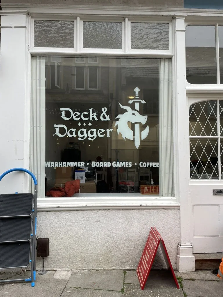 Deck and Dagger window signage