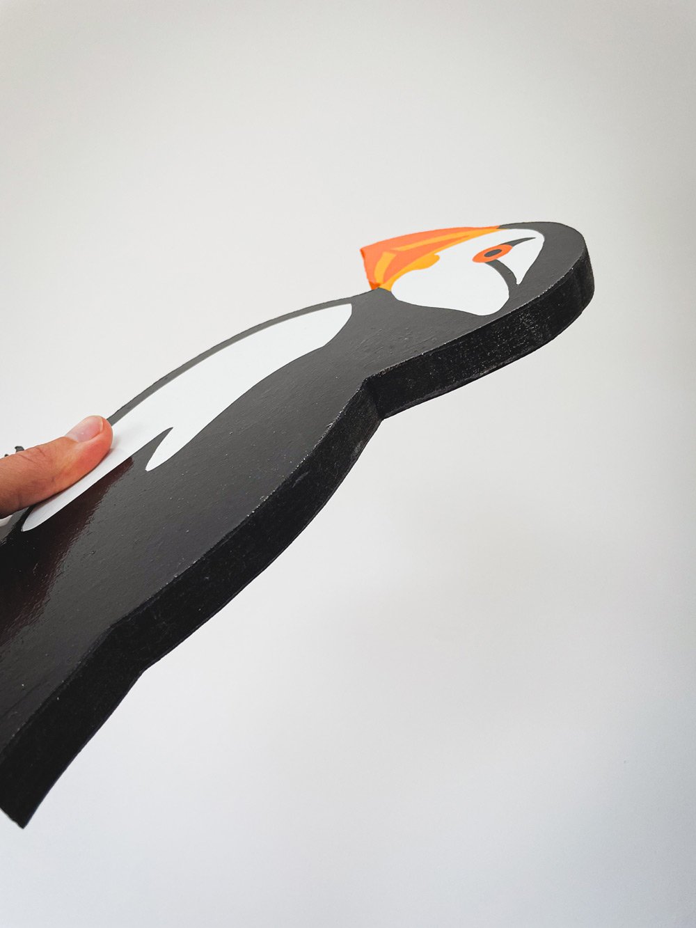 Hand-painted woodcut of a puffin, showcasing vibrant colours and detailed brushwork. The design captures the bird’s charm and character with expert craftsmanship and bold textures.