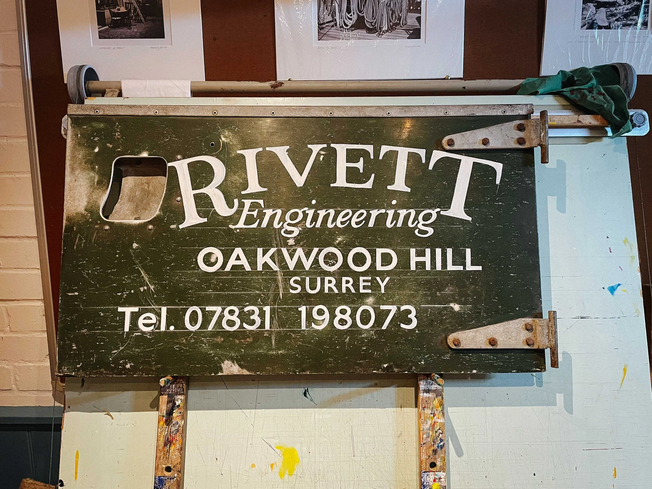 A hand-lettered sign on a Land Rover door, painted in Rich C Studio’s signature style, bringing personality and warmth to the space.