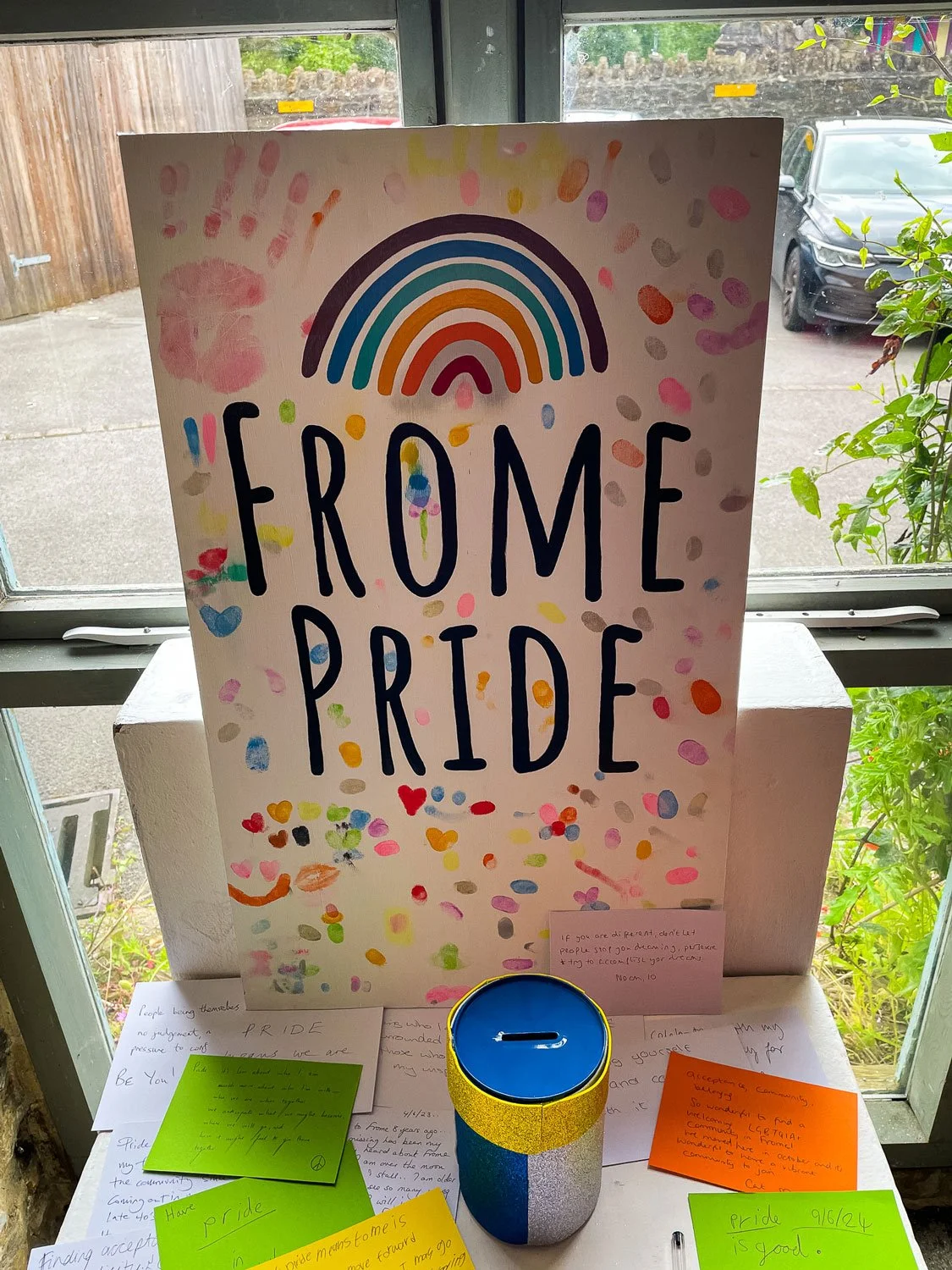 Hand-painted signage commissioned by Frome Pride 2024. This piece was used as an interactive display piece which encouraged attendees to add their own finger prints to the painted sign. The final sign featured bold, custom lettering, vibrant colours 