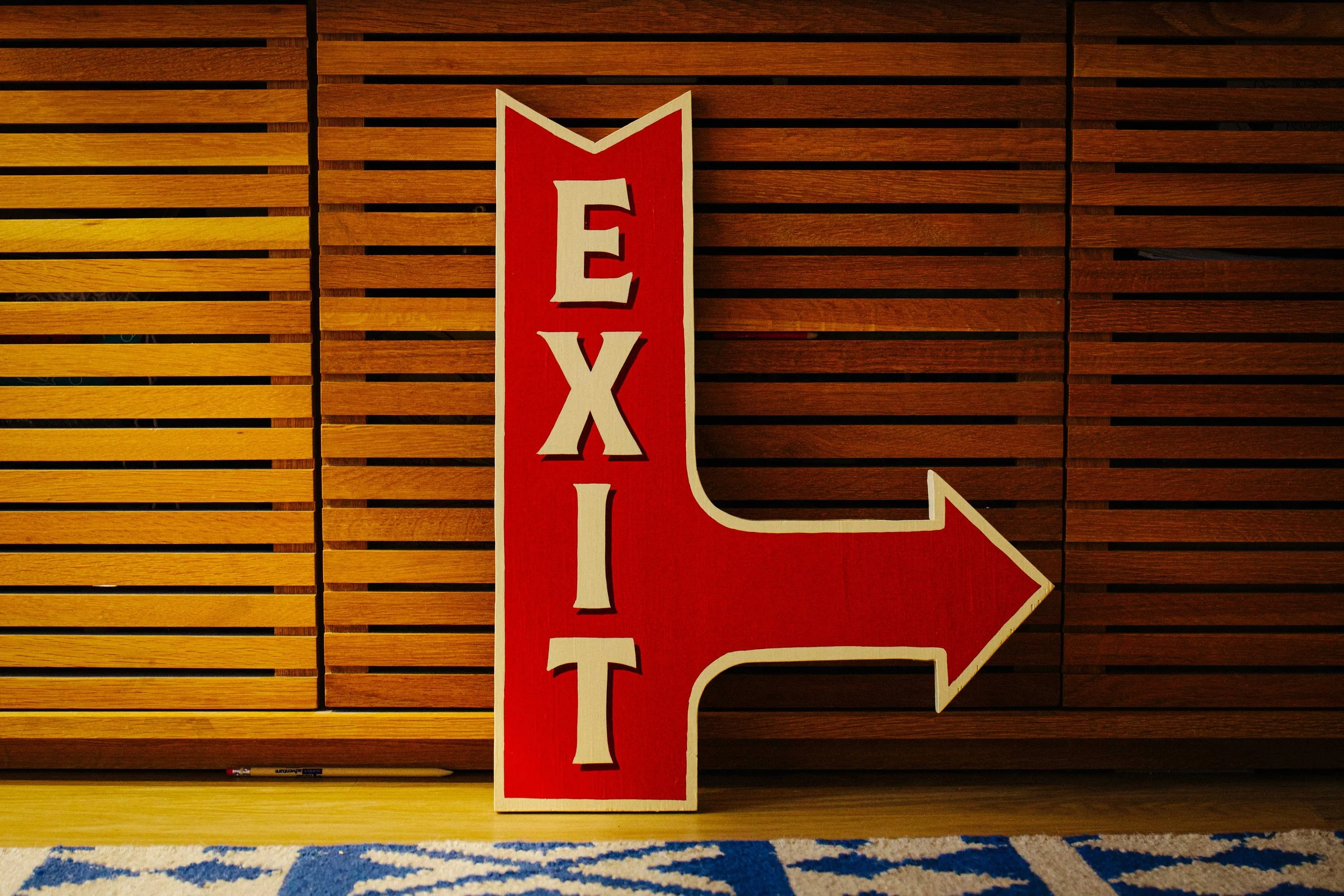 A hand-painted sign featuring bold, custom lettering in vibrant colours, showcasing the craftsmanship of Rich C Studio.