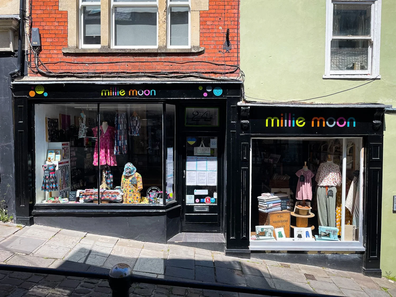 Hand-painted shop front for Millie Moon in Frome, featuring bold, hand painted lettering in vibrant colours, showcasing the craftsmanship of Rich C Studio.