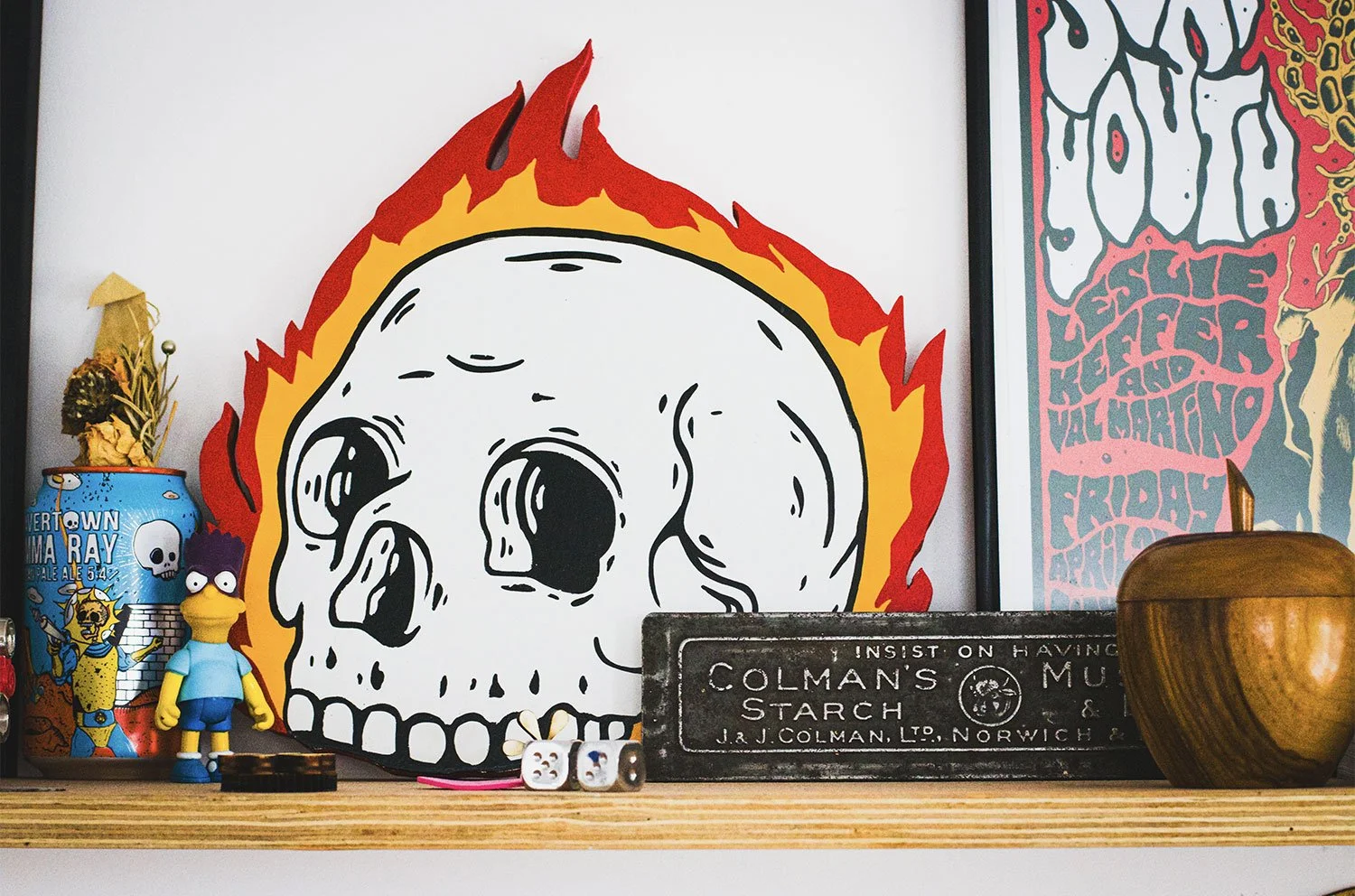 Skull on fire sat on a shelf inside Rich C Studio