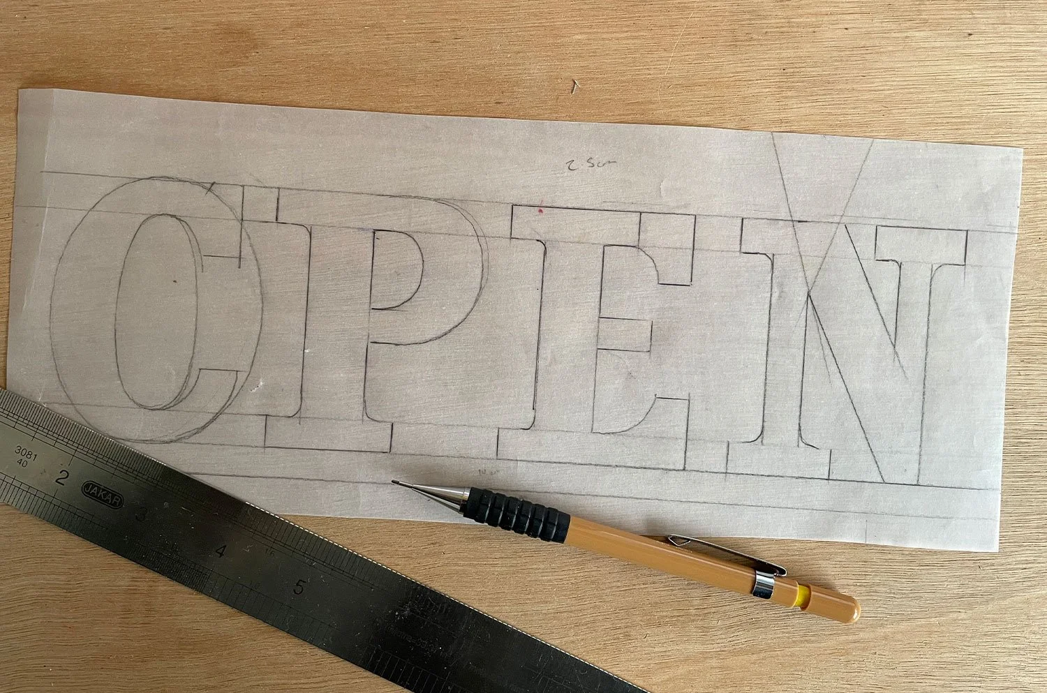 A behind-the-scenes shot of Rich sketching initial logo ideas, capturing the early stages of his creative process.