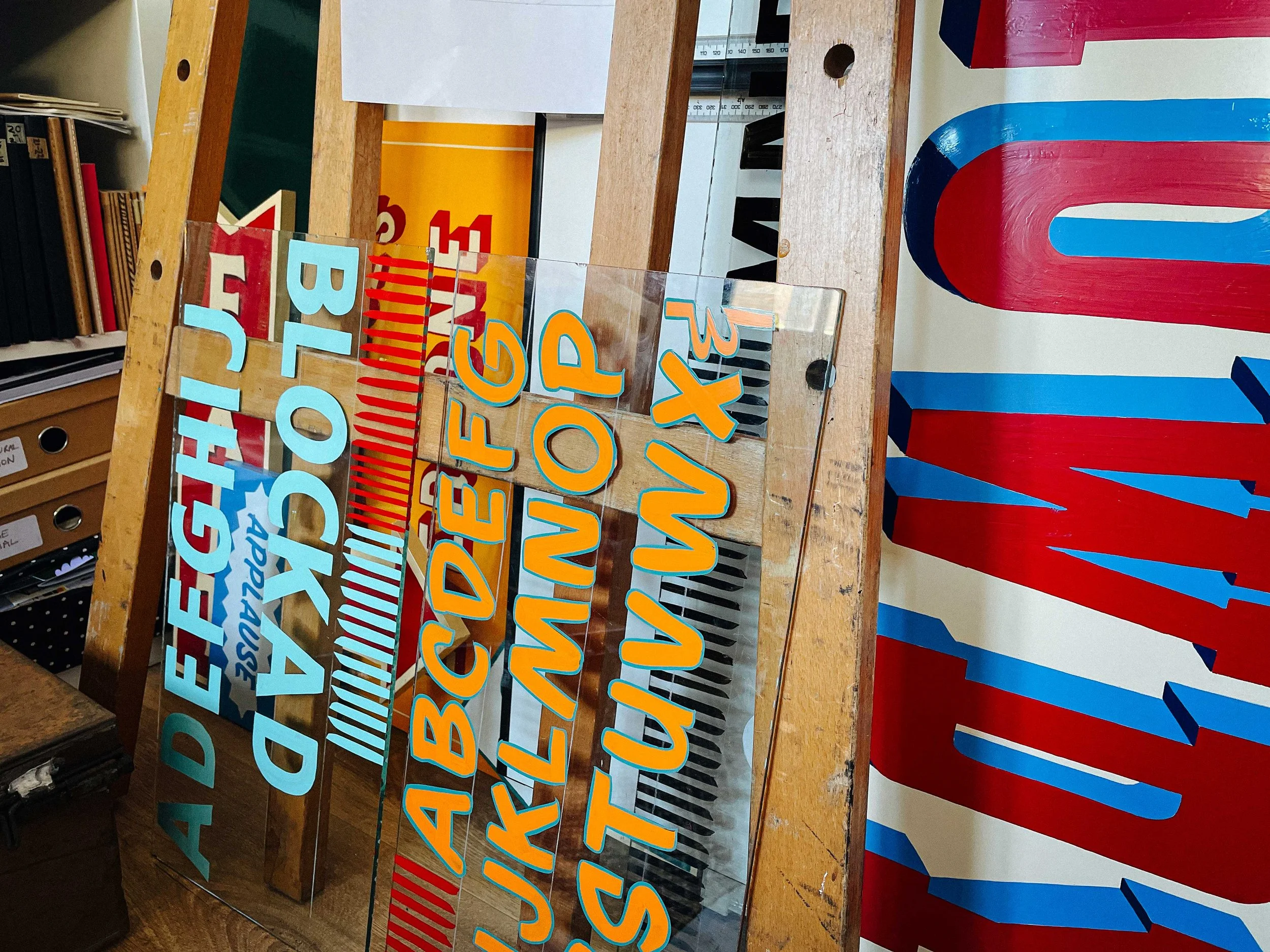 A wide angle shot of the Rich C Studio workshop, filled with brushes, paints, and tools of the trade, showing the hands-on, creative space.