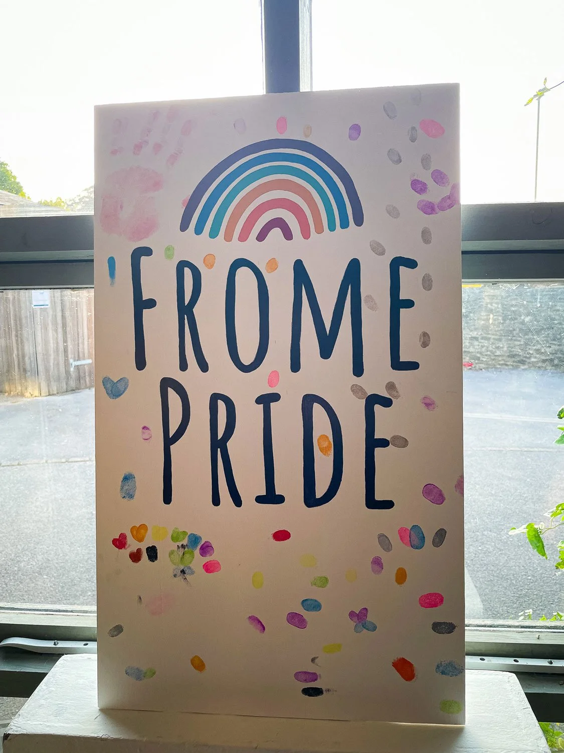 Hand-painted signage commissioned by Frome Pride 2024. This piece was used as an interactive display piece which encouraged attendees to add their own finger prints to the painted sign. The final sign featured bold, custom lettering, vibrant colours 