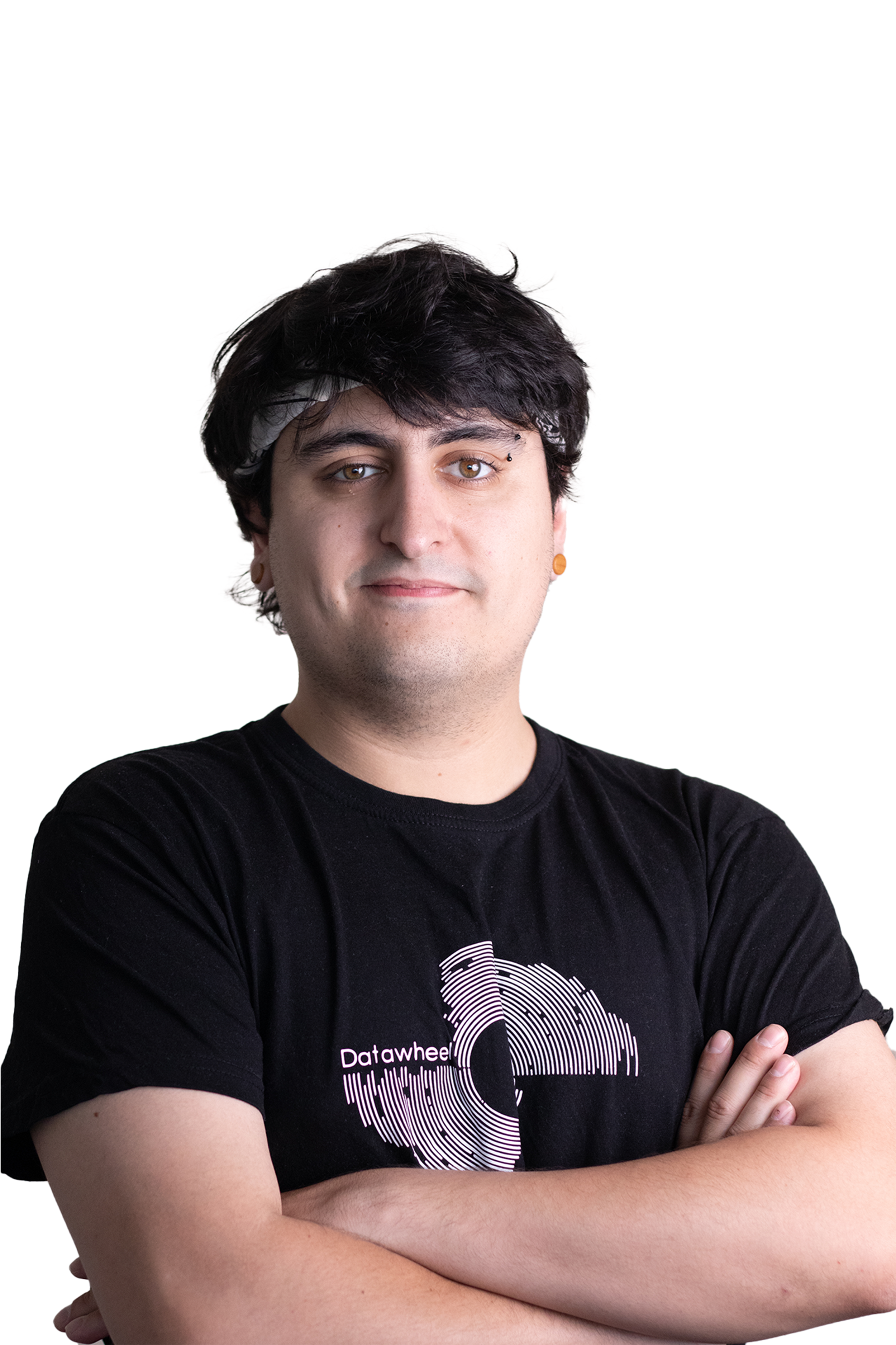 Young man with dark hair, wearing a black T-shirt with a white circular graphic and text, and crossing arms, standing against a white background.