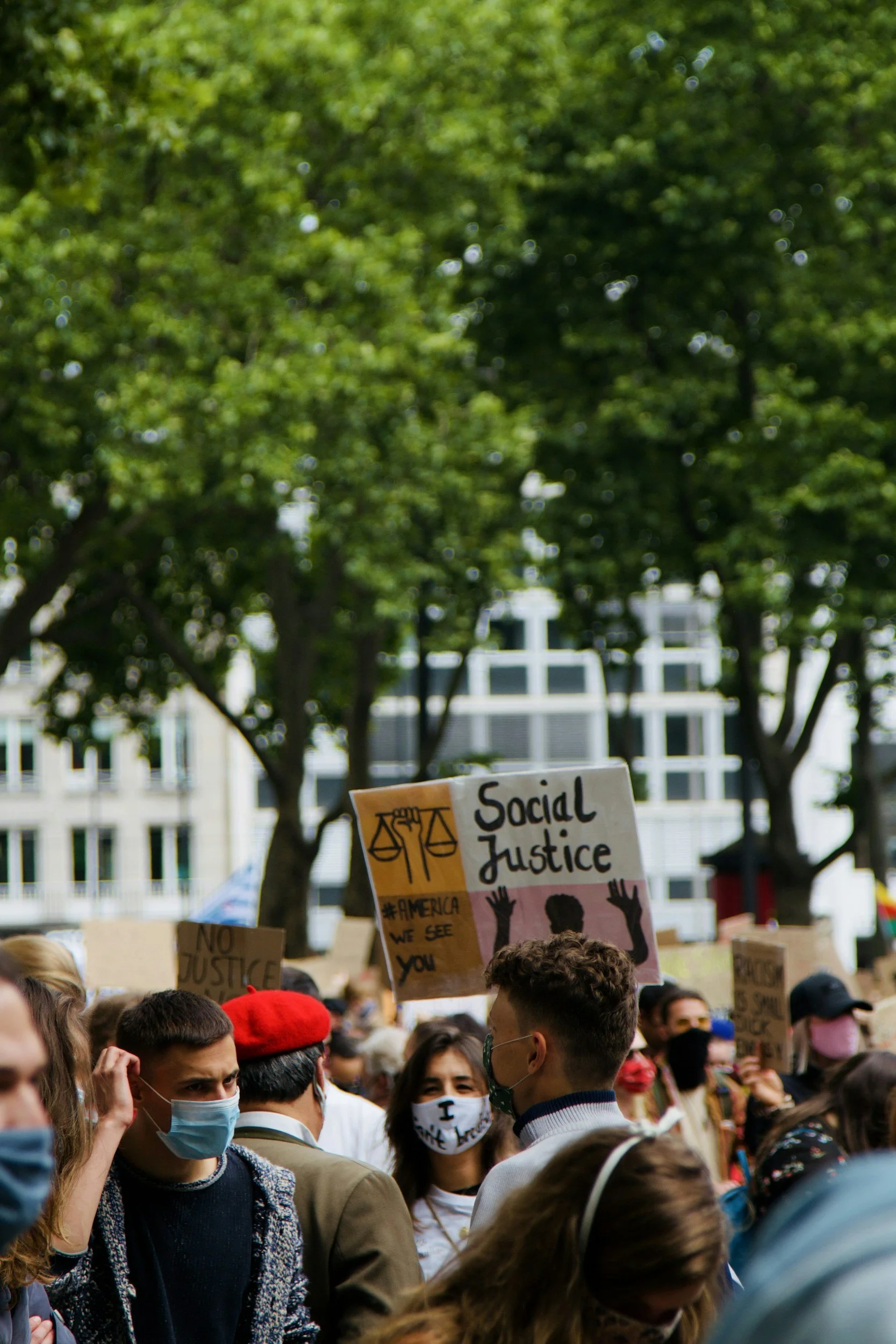 Person holding social justice placard at civic gathering