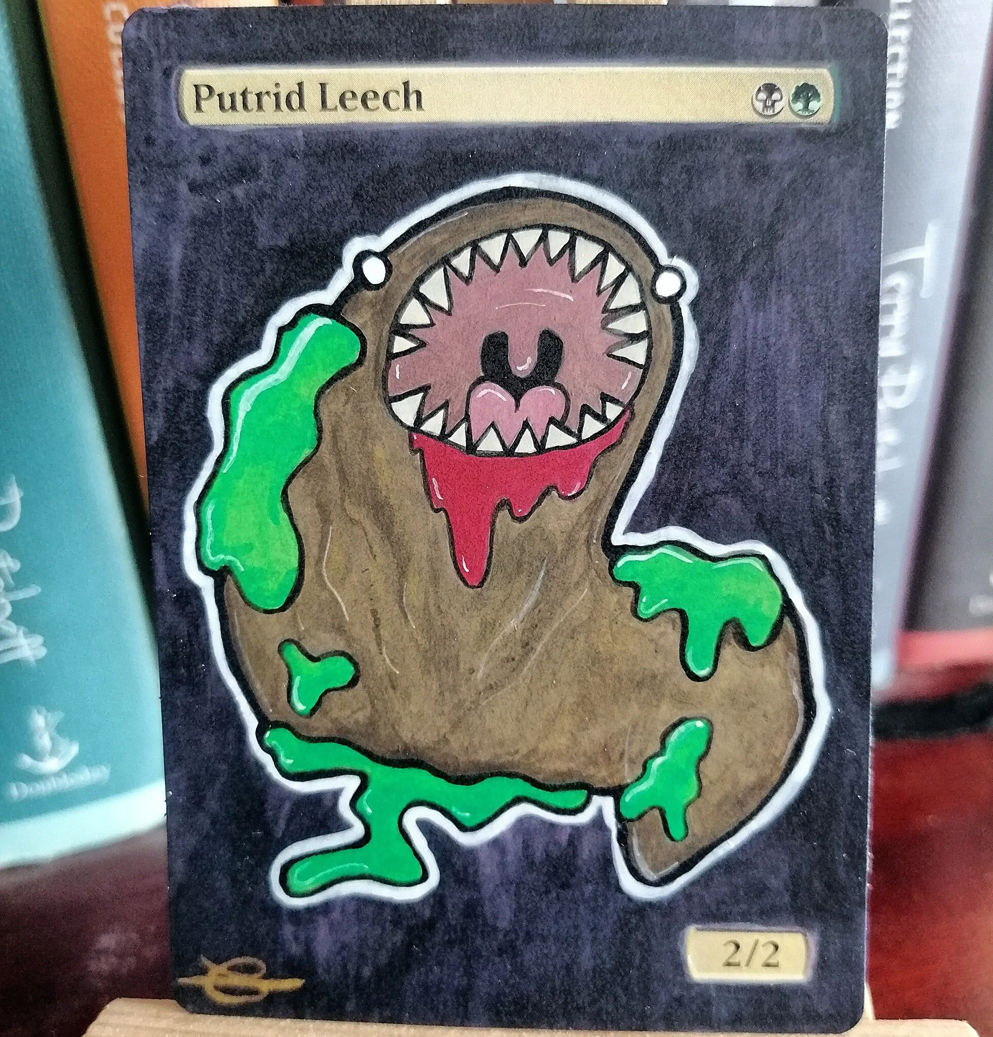 Putrid Leech MTG card alter - acrylic paint and ink, 2019.

Magic: the Gathering is a popular trading card game, and a large number of players like to have their cards customised (or altered) for aesthetic reasons. I started this particular kind of p