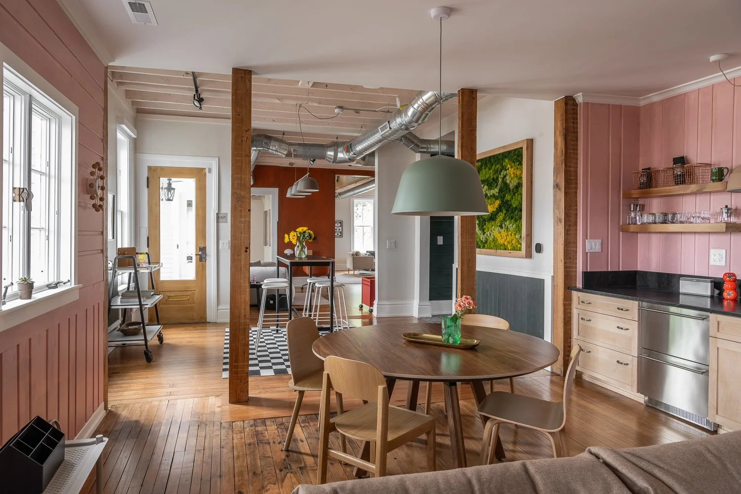 Take a seat&mdash;this corner of our showroom is all about easy gathering. A round wood table anchors the space, paired with clean-lined chairs and a bold pendant that brings it all together. It&rsquo;s a setting designed to spark conversation and le