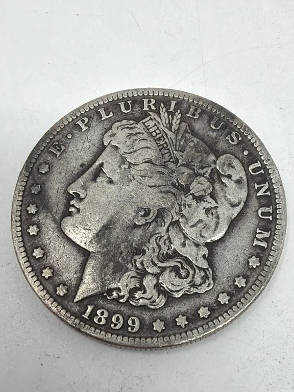 088 - Lot 76 - 1899-S silver Morgan dollar coin.jpg