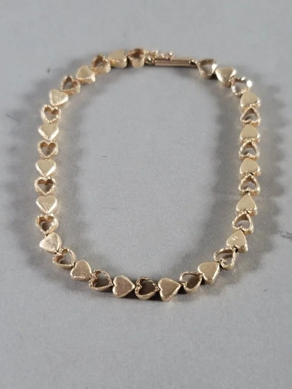 016 - Lot 447 - 14k gold gold bracelet with continuous miniature.jpg