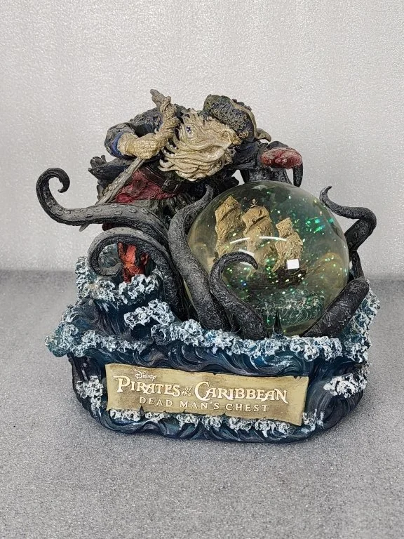072 - Lot 395h - Disney Pirates of Caribbean music box snow globe.jpg